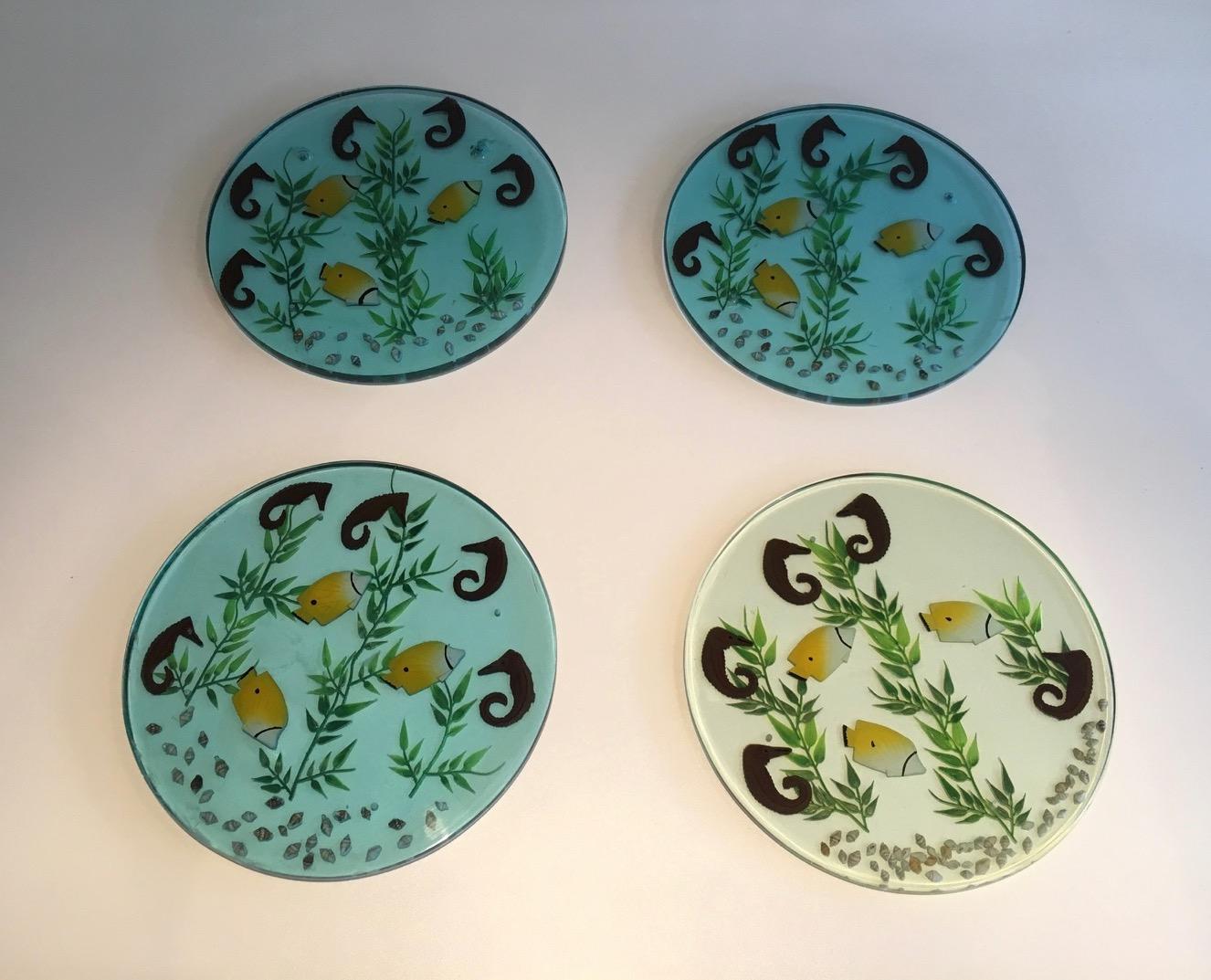 These 4 plates are made of lucite with incrusted seahorses, fishes, algues and shells. This is a French work. Circa 1970.