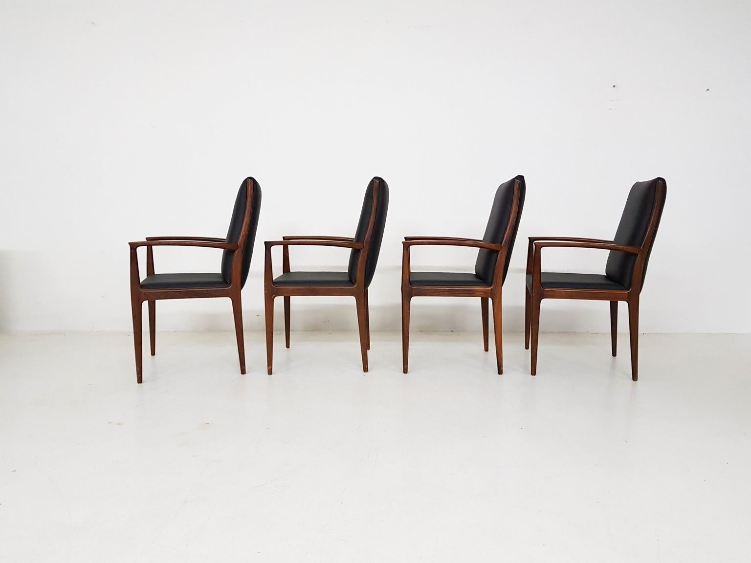 Set of four high end midcentury Danish design dining chairs in rosewood and leather. Made in the 1950s in Denmark.

We haven't found its designer yet, but reminds us of the chairs by Ole Wancher, Johannes Andersen and Arne Vodder.

With new