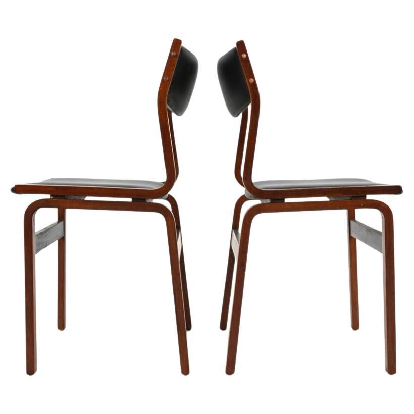 Set of (4) Danish modern dining chairs In the style of Arne Jacobsen for Fritz Hansen. Rosewood over bentwood and upholstered in black vinyl. Made in Denmark circa 1970. 

Dimensions: H 33