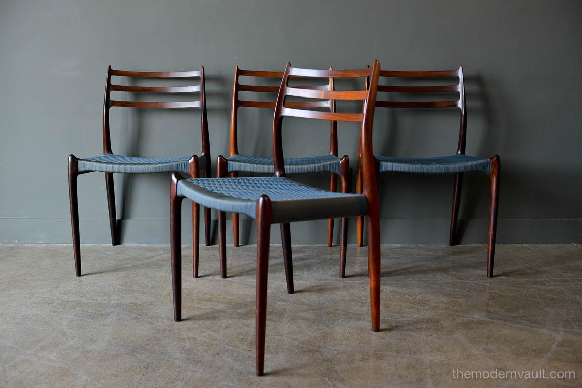 Set of 4 rosewood model 78 dining chairs by Niels O. Moller, circa 1960. Set of 4 original Niels O. Moller with original blue wool cording in excellent vintage condition. Sculpted rosewood frames with beautiful grain. Sold as a set of 4. Sourced