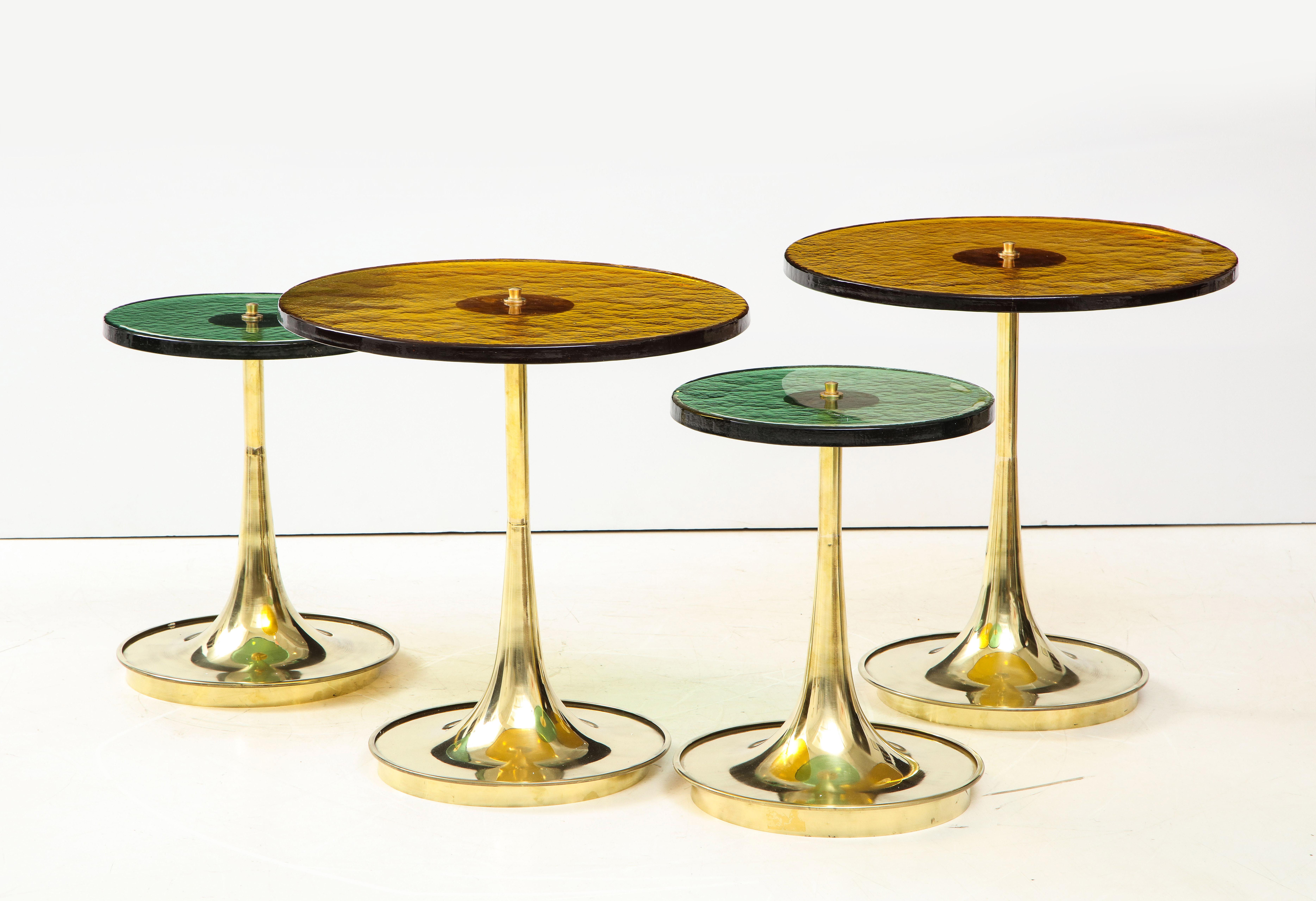 Set of four (4) round bronze and emerald green murano glass and brass martini or side tables, Italy. Hand-casted thick and solid bronze colored and emerald green Murano round glass tops sit on hand-turned trumpet-shaped brass bases. Modern flat top