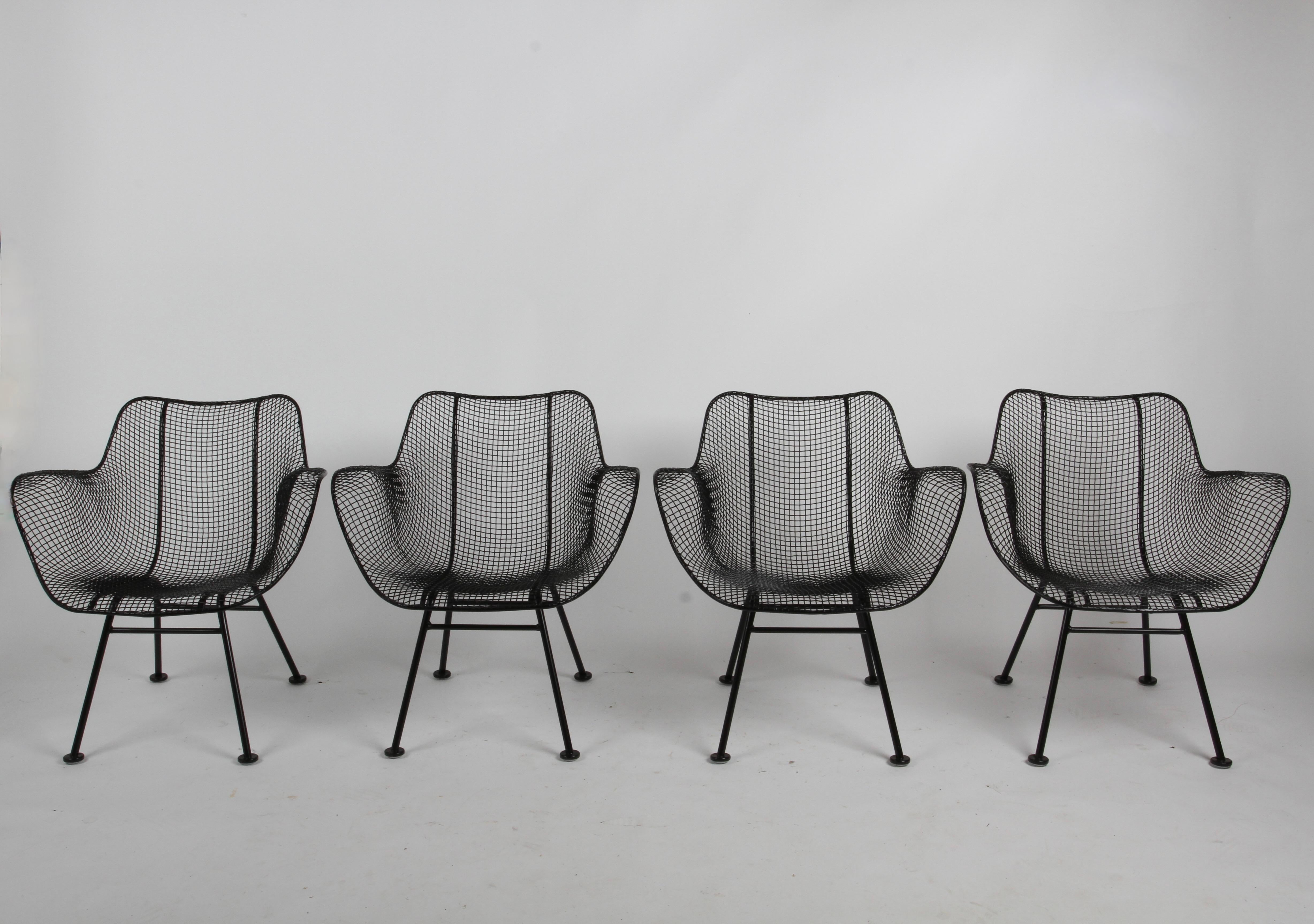 Newly restored set of four Iconic Russell Woodard Mid-Century Modern wire mesh lounge patio arm chairs from his 1950s Sculptura Line. Just back from the being sandblasted, dipped in rust inhibitor and painted in a satin black , with new glides. All