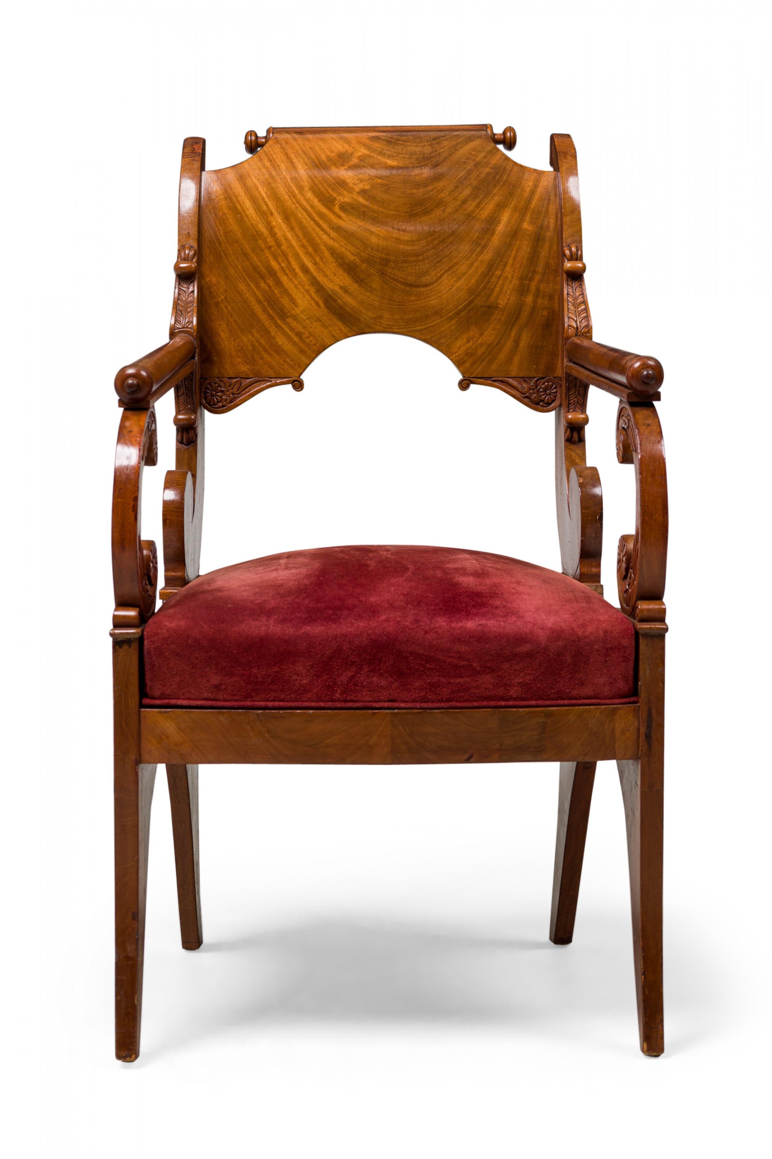 SET of 4 Russian neoclassic mahogany armchairs in elaborate scroll form with a curved upper backrest and arms, carved acanthus decoration with reeding and floral medallions, and red suede upholstered seats and cut out arched legs. (PRICED AS SET).