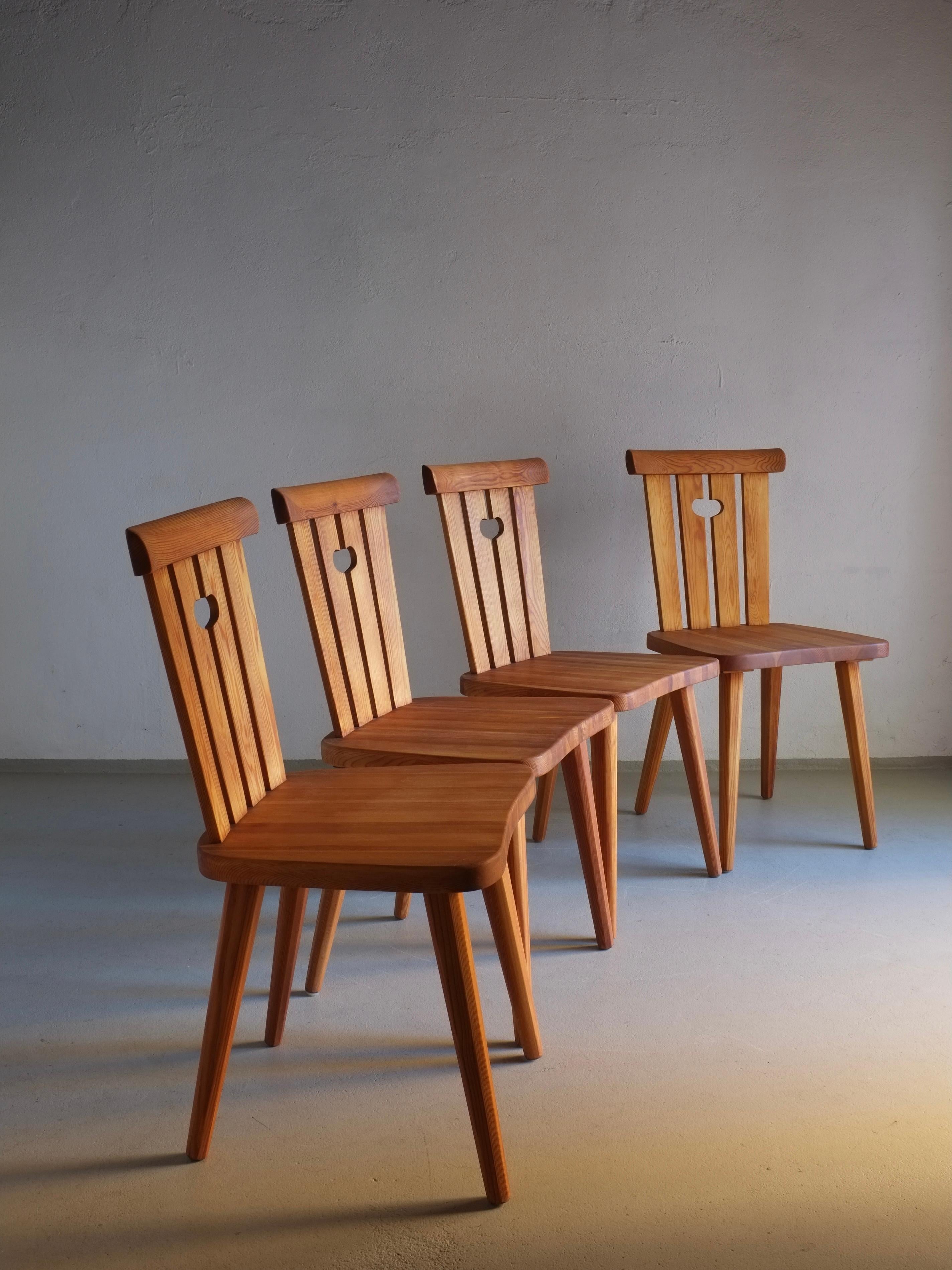 Set of 4 solid pine dining chairs designed by Göran Malmvall in the 1940s. The chairs have been restored and oiled. I have 2 more chairs in stock in original condition.