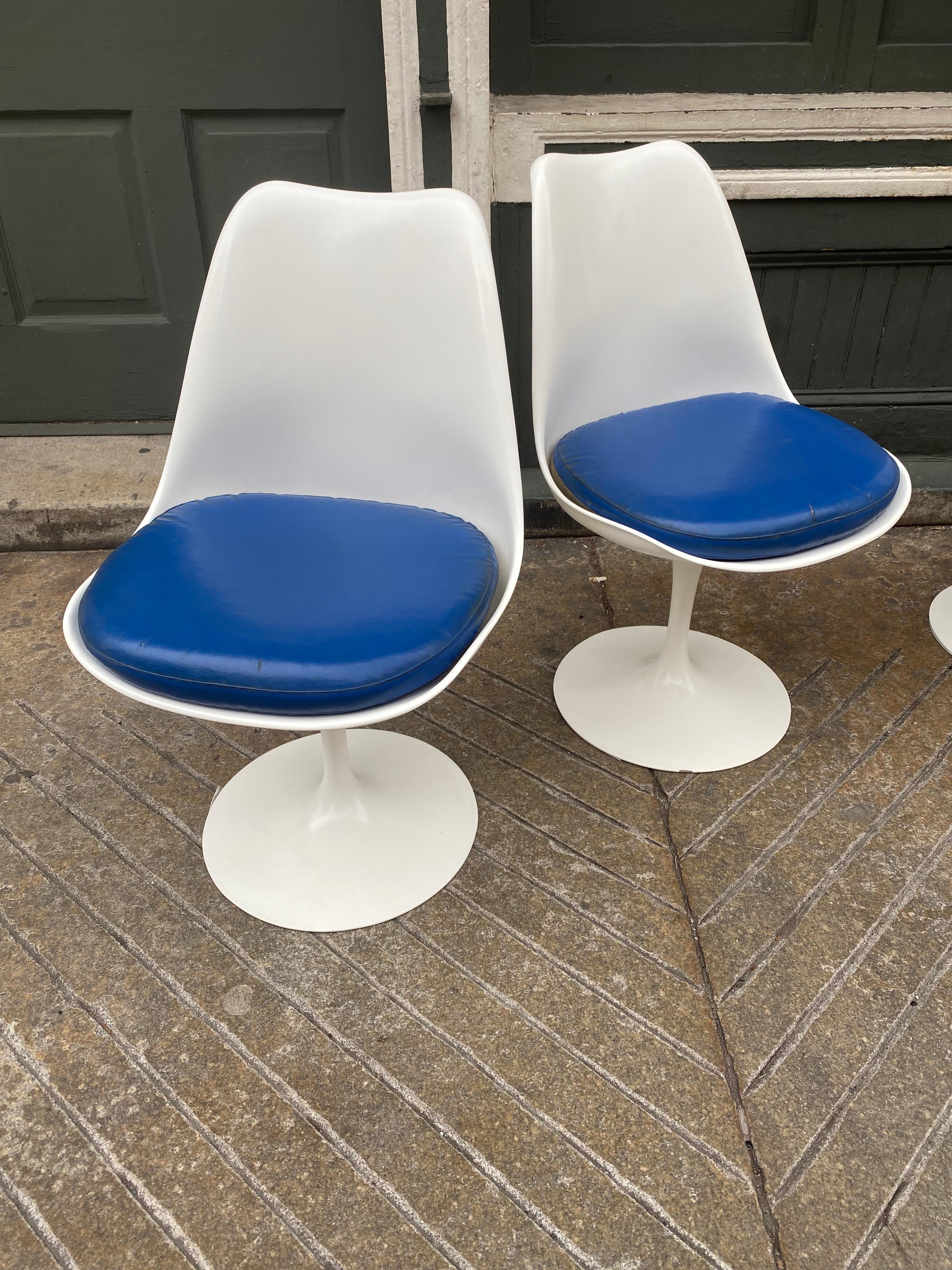 Set of 4 Eero Sarrinen for Knoll Swiveling Tulip side chairs. Chairs were repainted about 8 years ago and still look great! One chip to bottom edge as seen in photo. Vinyl Seat pads show their age but still function. Classic mid-century design at