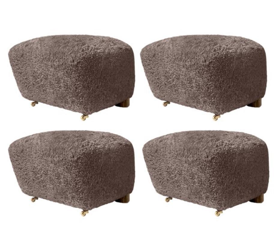 Set of 4 sahara smoked oak sheepskin the tired man footstools by Lassen.
Dimensions: W 55 x D 53 x H 36 cm 
Materials: Sheepskin

Flemming Lassen designed the overstuffed easy chair, The Tired Man, for The Copenhagen Cabinetmakers’ Guild