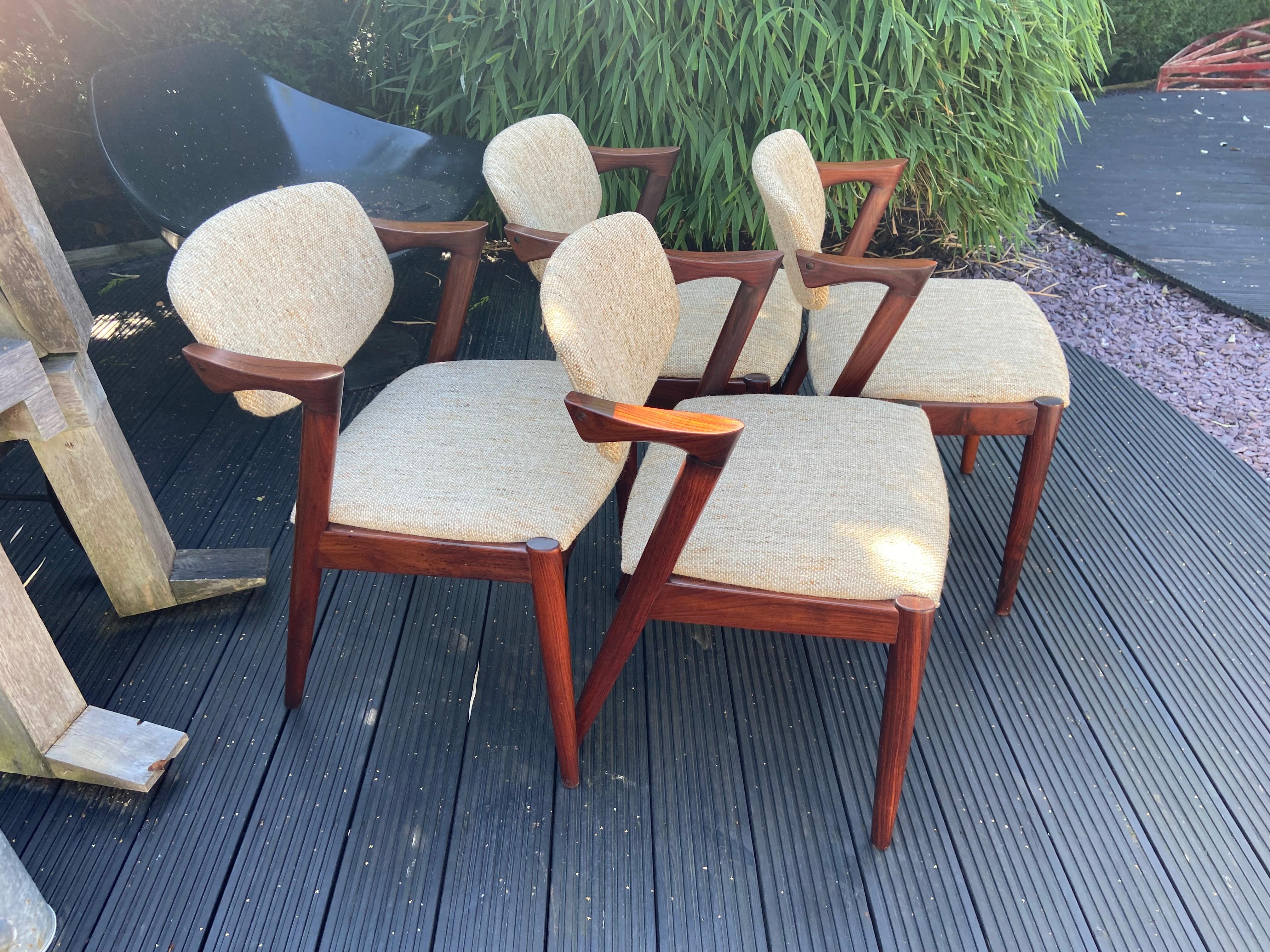 Very nice set of 4 chairs, the nicely figured solid Santos Rosewood is in very good condition, and the original quality wool fabric seats have been professionally cleaned, rewebbed and are also in very good condition.