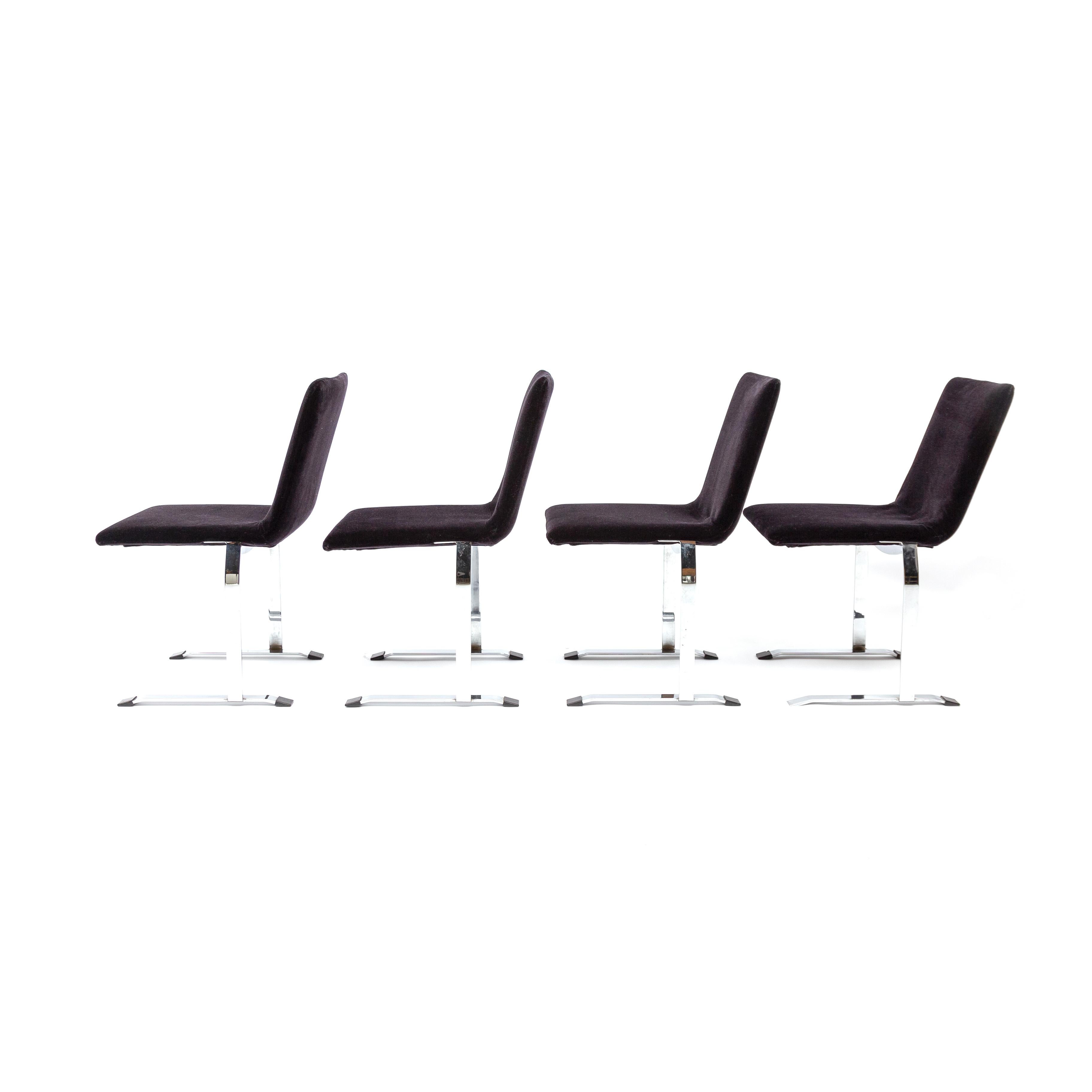 Distinctive & expressive steel sled bases with bright, chrome plated finish and airy, cantilevered form. All four original black plastic feet present. Solid, sturdy, and comfortable. Recently reupholstered in a beautiful black mohair velvet. 

No