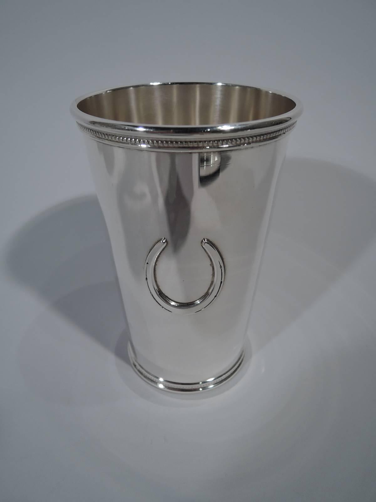 Set of four sterling silver highballs. Made by Scearce in Shelbyville, Kentucky. Straight and tapering sides. Rim and base molded with flat beading. Horseshoe applied to side. Great for seasonal horsey events. Hallmark includes presidential date