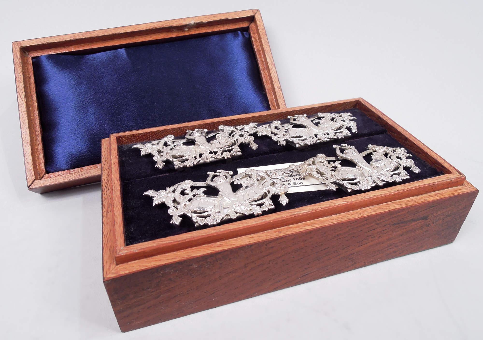 Set of 4 Victorian sterling silver novelty place card holders. Made by Brook & Son in Edinburgh in 1899. Each: A cast open scene with drumming monkey, sticks raised overhead; mounted to shaped frame with open support. In stained-wood case with