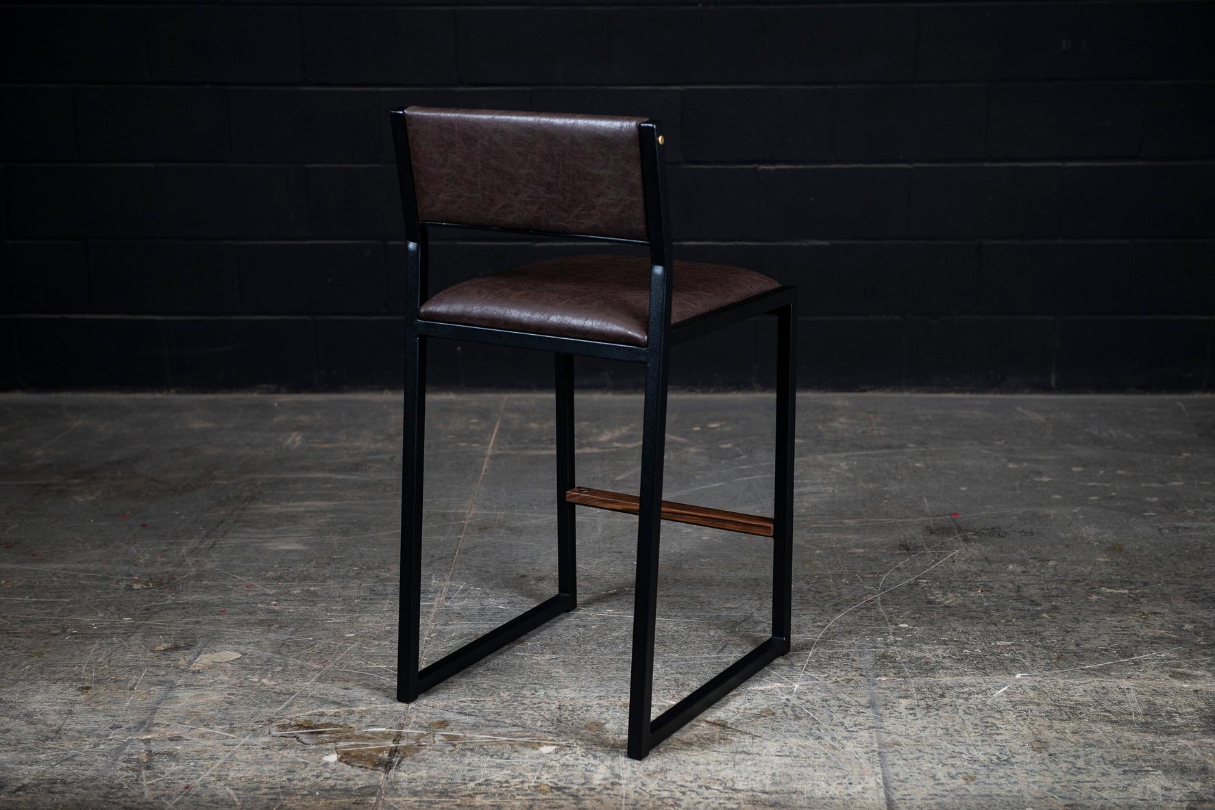 The shaker modern counter stool chair is handmade to order from our unique Ambrozia black textured steel tubing frame and a premium vinyl upholstered seat & back. Also offered in Leather, Cowhide & COM or COL. Inspired by the boarding ladder steps