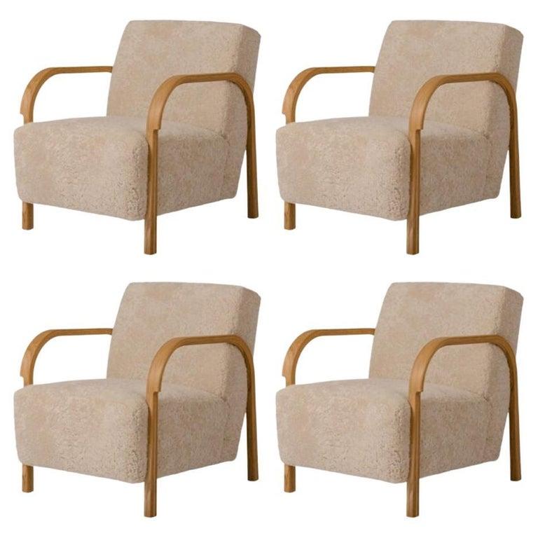 Set of 4 Sheepskin ARCH Lounge Chairs by Mazo Design
Dimensions: W 69 x D 79 x H 76 cm
Materials: Oak, Sheepskin. 

With the new ARCH collection, mazo forges new paths with their forward-looking modernism. The series is a tribute to the renowned