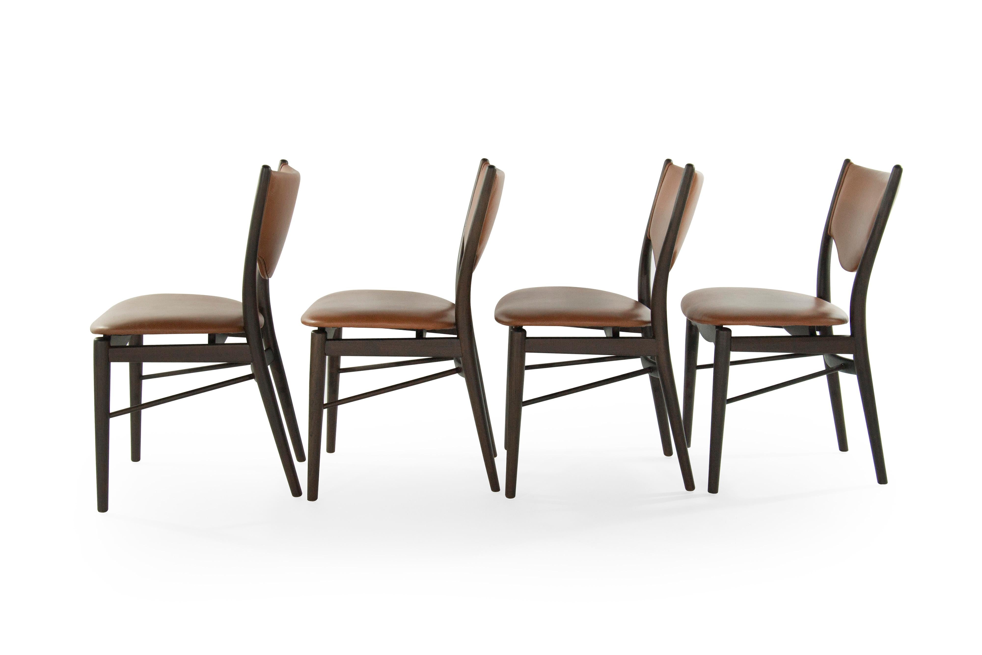 Set of four BO-63 dining chairs by Finn Juhl for Bovirke, circa 1952. This special set has undergone a top to bottom restoration process. Sculptural darkened beech wood frames with a newly applied matte finish. Gently curved backs that follow the