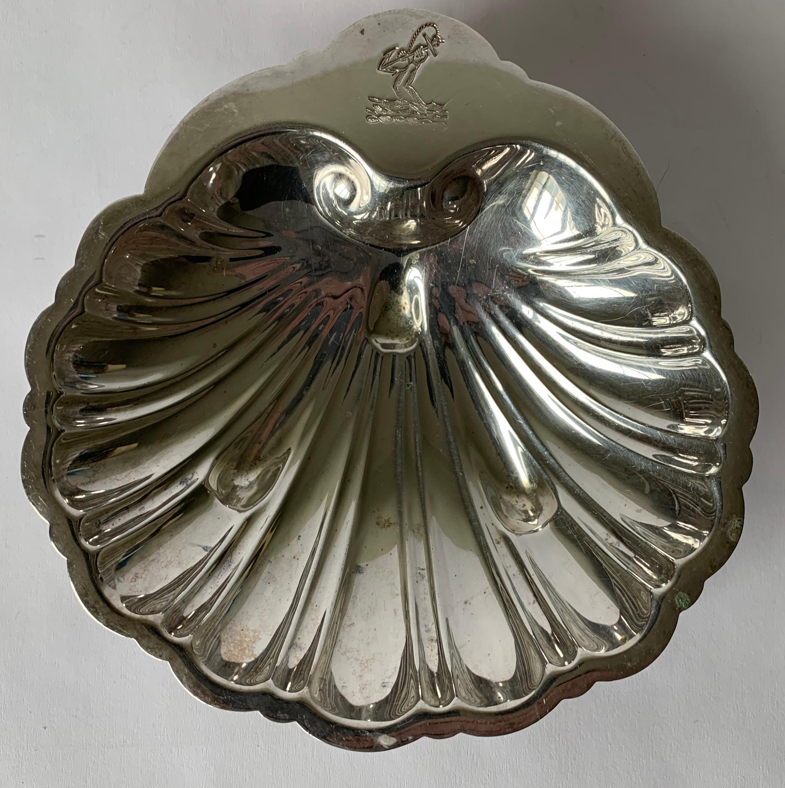 Set of 4 silver plated shell candy dishes. Stamped on the underside “Made expressly for Douglass Lorie, Palm Beach Fla.”