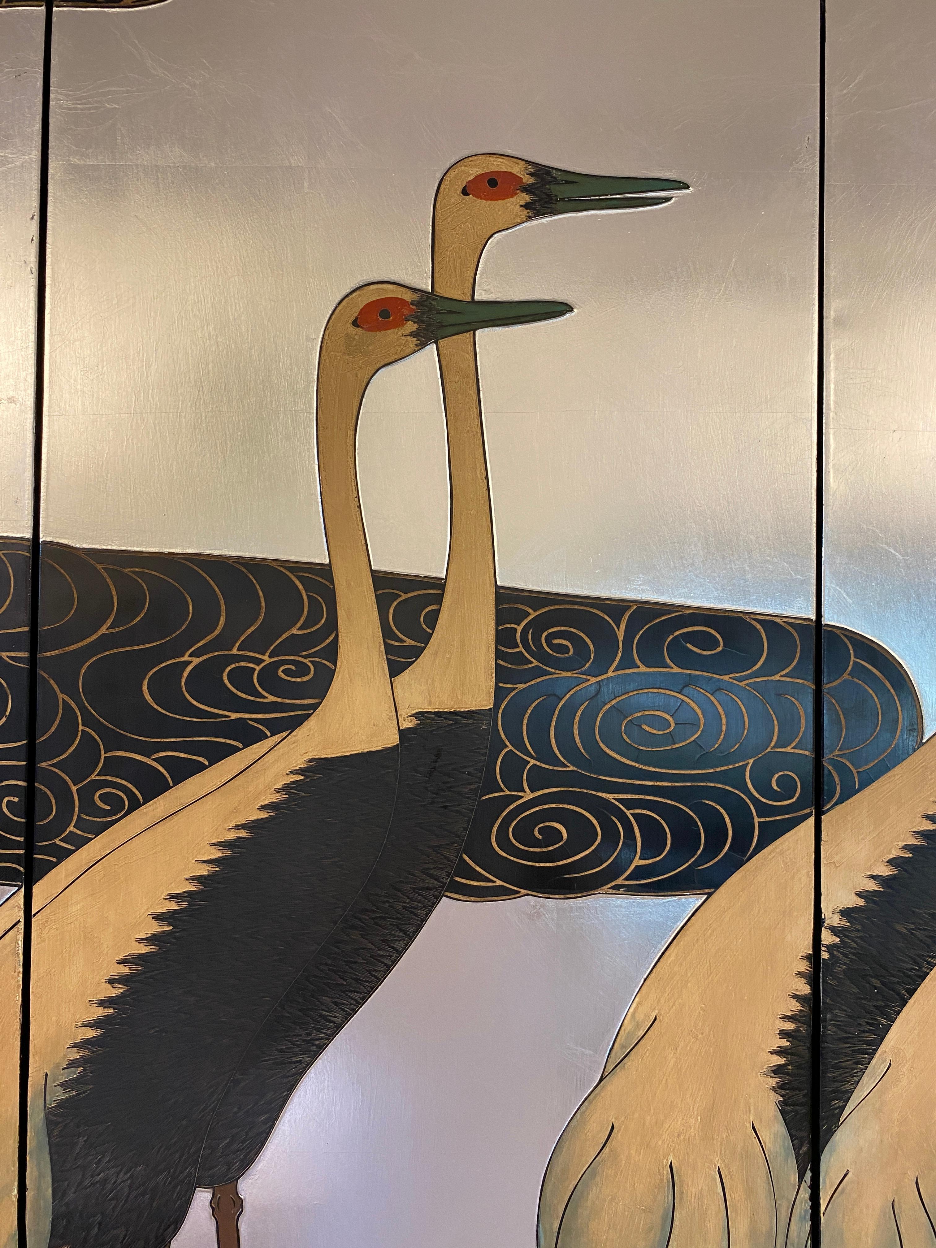 Stunning Japanese art panels displaying the beauty of 6 cranes.

This bold and innovative composition presents a grouping of white-naped cranes extending across a set of four Japanese panel screens. The 6 cranes in this work, grouped in rhythmic