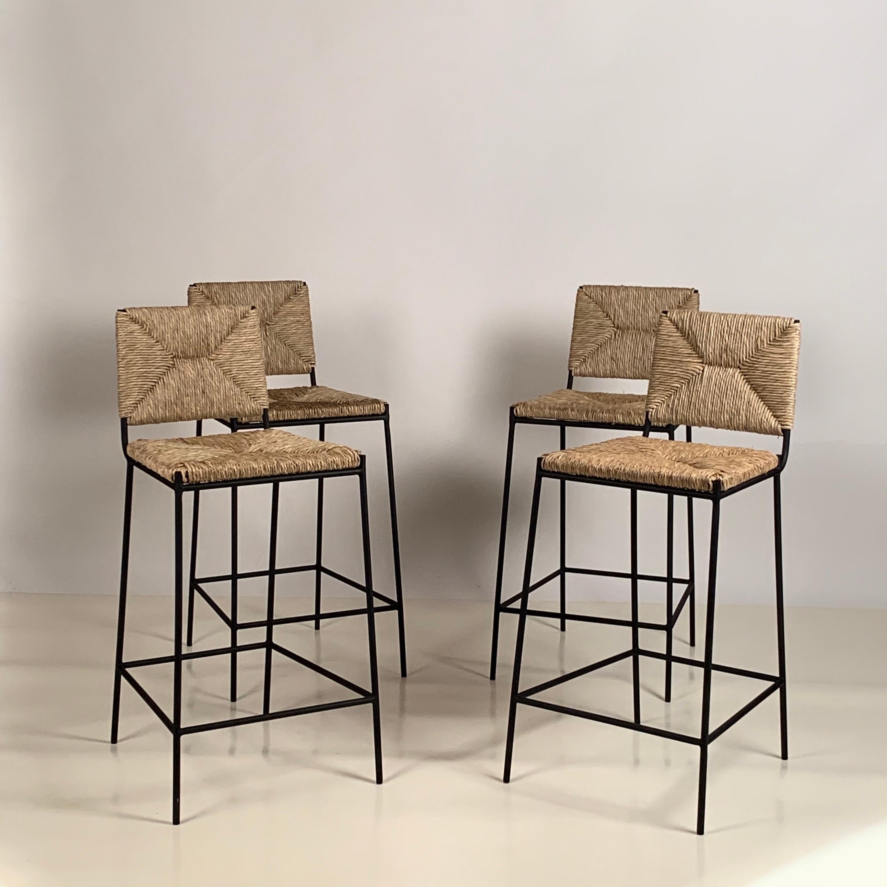 Set of 4 slender 'Campagne' counter stools by Design Frères.

Comfortable, with a minimal footprint.

Extra support under the rush seat.

Feet pads to protect flooring.