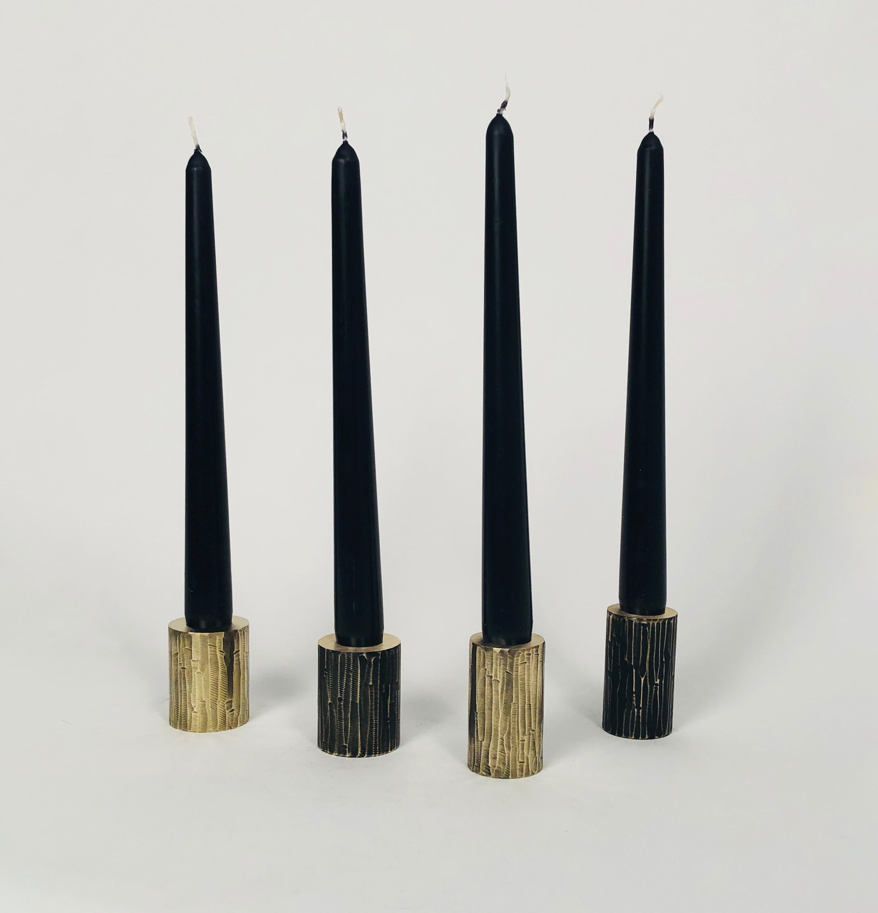 Set of 4 solid brass sculpted candleholders by William Guillon 
Each is signed William Guillon
Dimensions: Diameter 4 x height 5 cm
 Diameter 3.5 x height 6 cm
Materials: Solid brass raw finish or patinated black, with polished edge
Hand-sculpted in