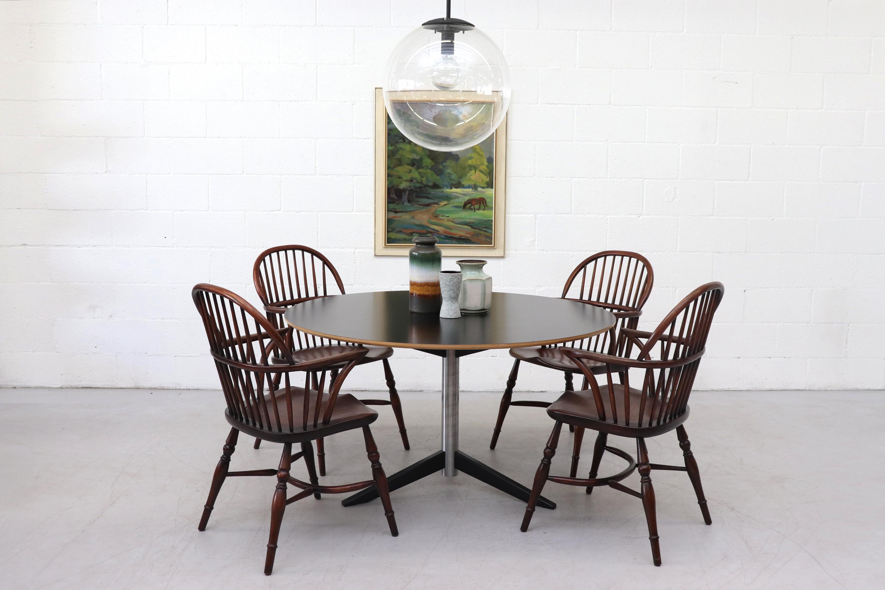 Beautiful set of 4 Windsor armchairs. Lightly refinished with Rustic style and beautiful wood work. In original condition with minimal wear or scratching. Shown with Martin Visser TE06 dining table ( LU922416005961), RAAK style globe pendant ()
