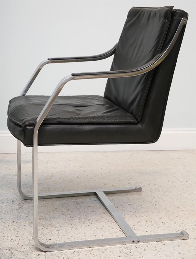The steel frame with black leather upholstered seat, back and armrests. An interpretation of the BRNO chair.