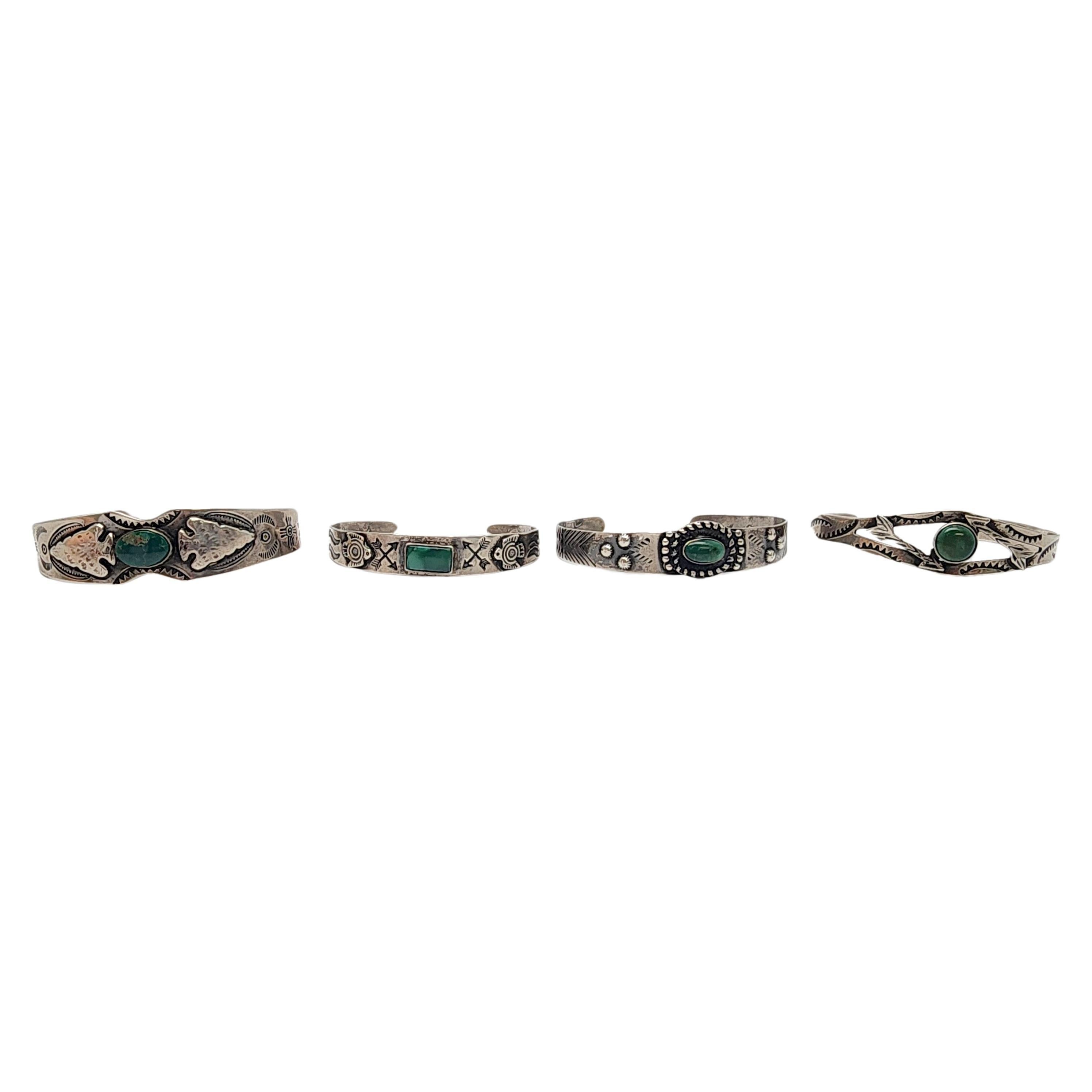 Set of 4 sterling silver and green turquoise Fred Harvey Era cuff bracelets.

Four beautiful cuff bracelets in Fred Harvey style featuring open work designs, green turquoise stones and Native American symbols.

Weighs approx 44.6g, 28.7dwt