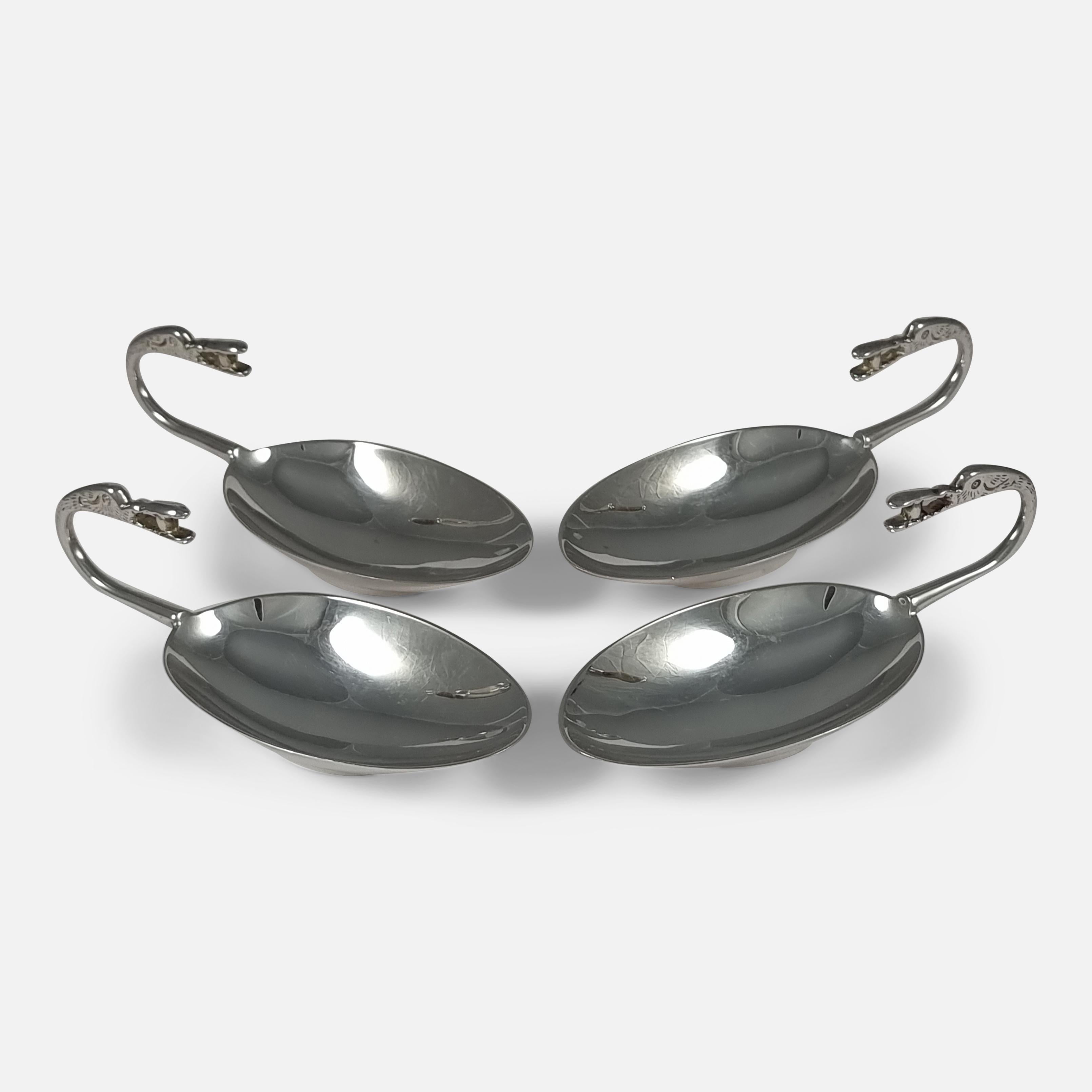 A set of four sterling silver Traprain Dishes or Tastevins, replicated from a design found in the Roman silver hoard at Traprain Law, Edinburgh, Scotland, in 1919. The dishes have an egg-shaped bowl on a foot, with a handle ending in a mythical