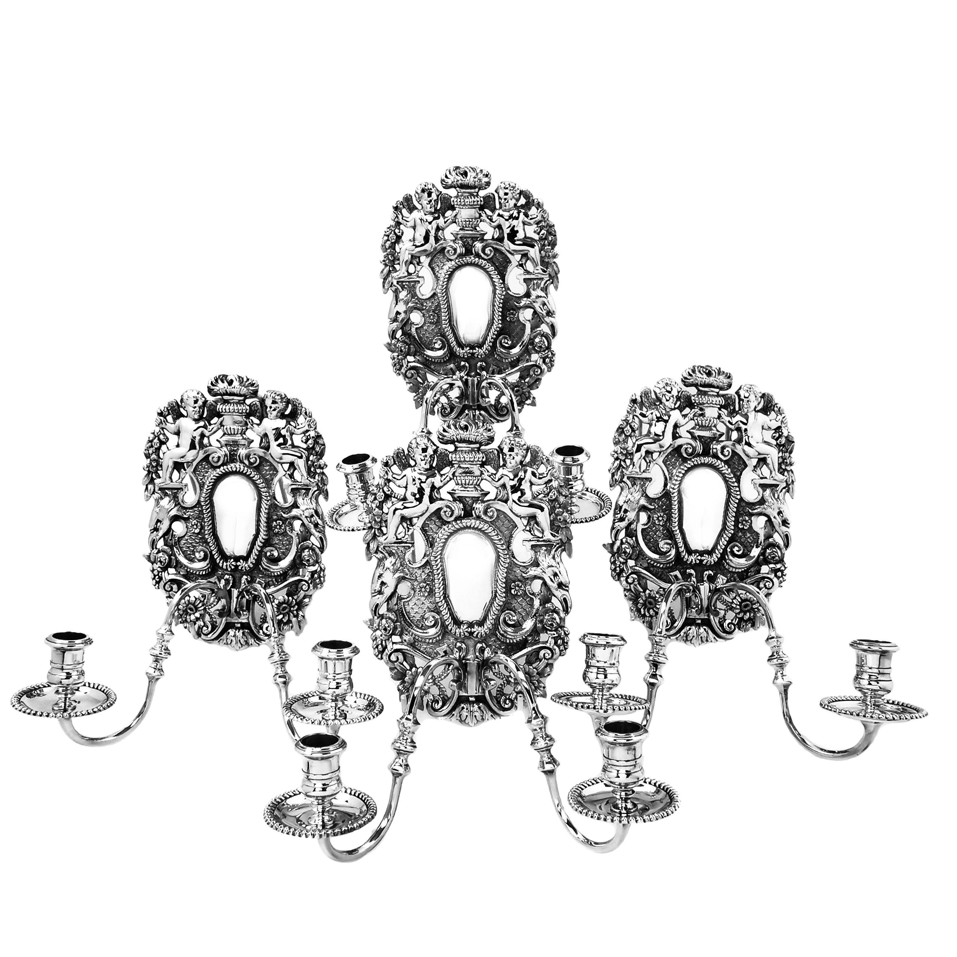 A magnificent set of four solid Silver Wall Sconces for Candles in the late 17th century William III style. This set of four Candle Sconces are a special commission piece retailed by James Robinson of New York but made and hallmarked in England. The
