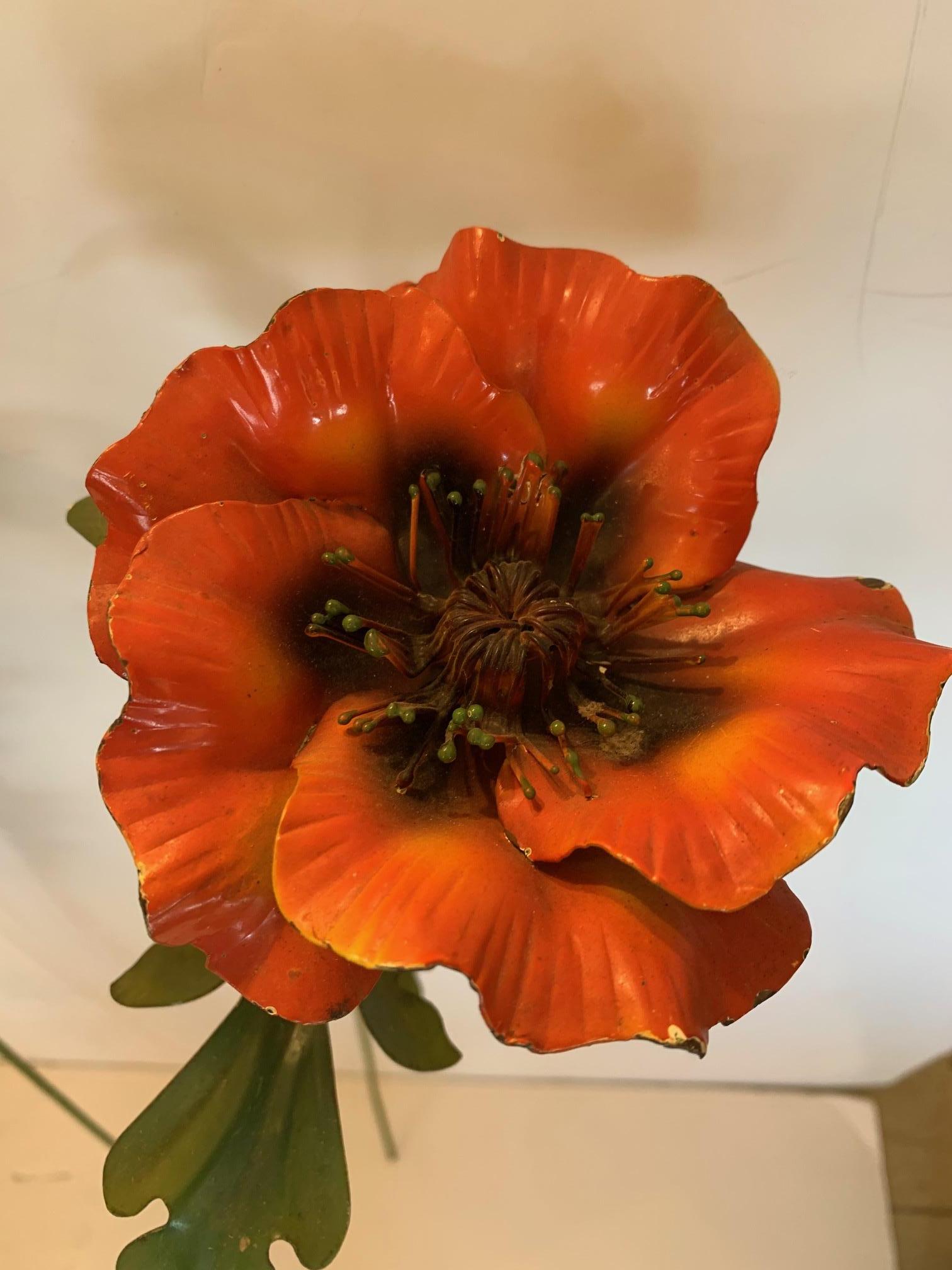 A wonderful decorative set of 4 elongated painted iron poppy flowers having orange and black flowers and realistic green foliage. Great in a large vase for sculptural flower art!