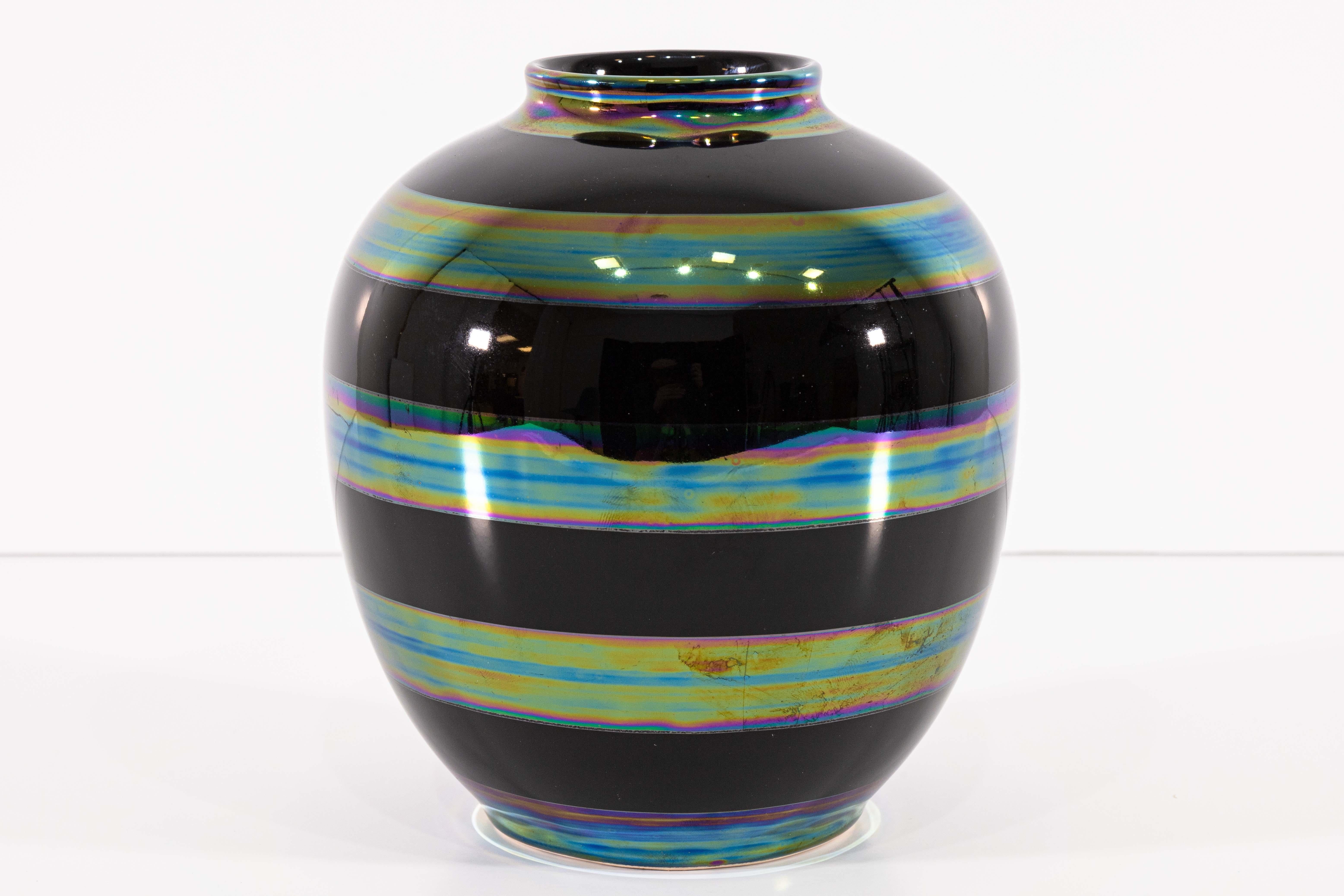 Un set di 4 vasi in ceramica iridescente a righe. Questo bellissimo set di vasi presenta una splendida finitura a righe con strisce iridescenti e brillanti. Questo set presenta una varietà di forme e dimensioni ed è perfetto come elemento