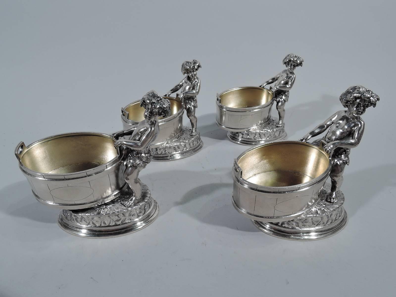 Set of four Classical sterling silver open salts. Each: A barrel with staves and hoops is supported by cast figure of Bacchus. A fetching youth with wide crouching stance and grapevine-encircled pelvis thrust against barrel. Stylish and provocative