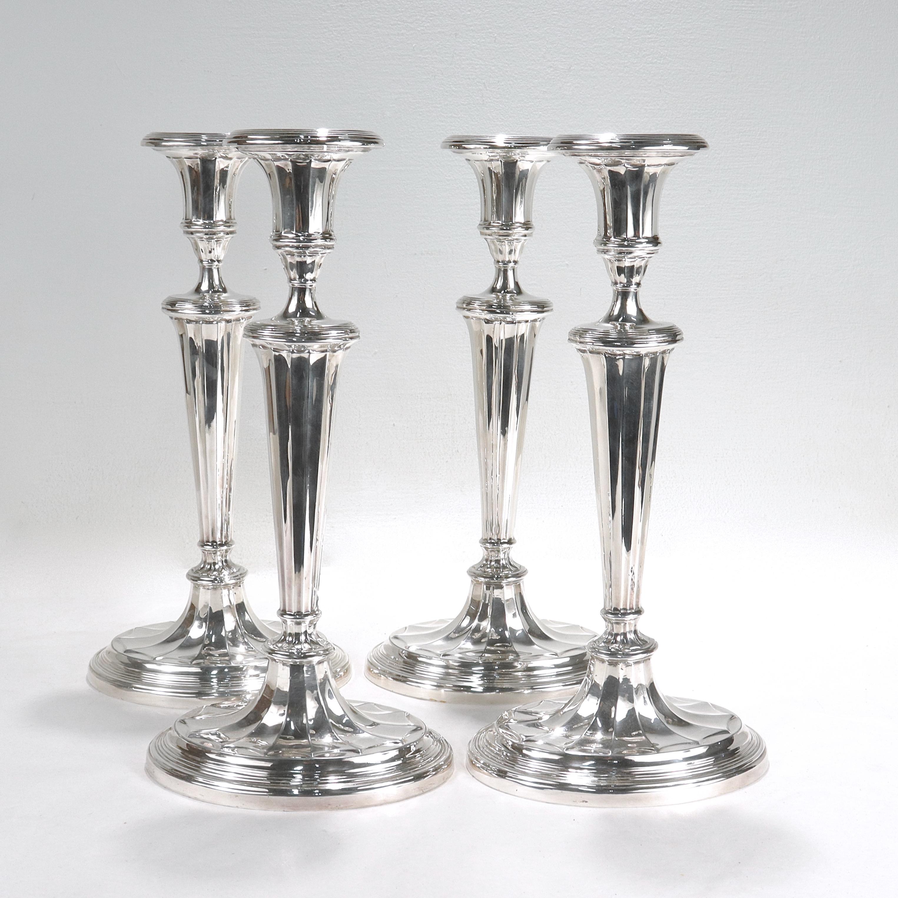 A fine set of 4 matching silver plated candlesticks.

In the Regency style. 

Having an oval form with shaped candlecups, fluted sides, and a stepped base. 

Each has a felt padded base.

Simply a wonderful set of high style