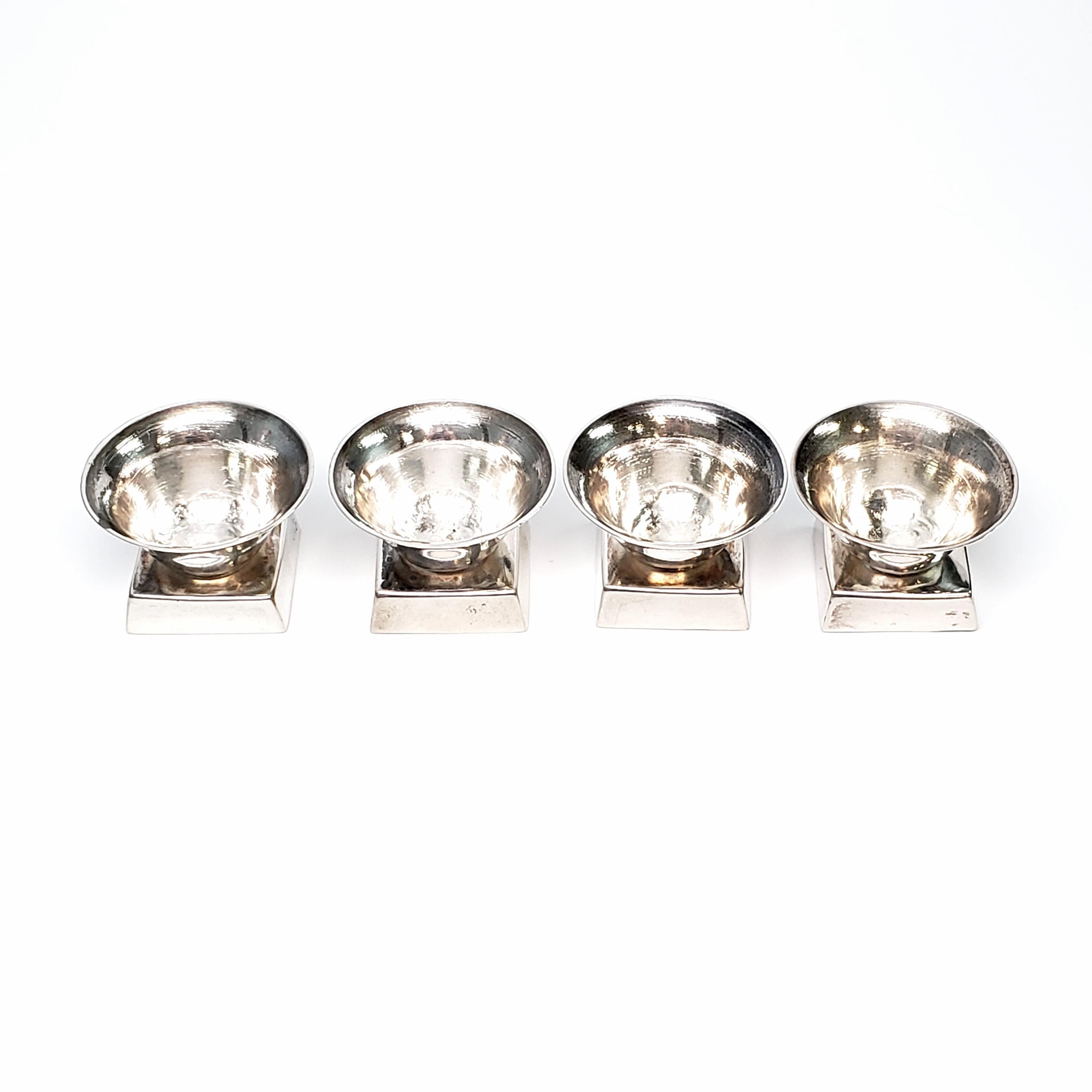Set of 4 Taxco Mexico William Spratling sterling silver salt cellars, circa 1939-1940.

Salt cellars feature round bowls on a square pedestal base.

Measures approximate 1 1/2