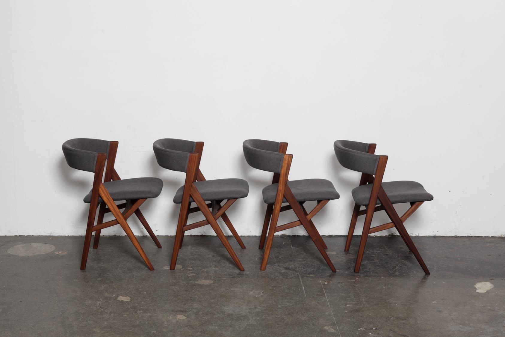 Danish Mid-Century Modern 1950s wraparound curved back teak dining chairs with 'A' frame and upholstered back and seat. These have been newly refinished in a natural teak oil finish and have been upholstered in a dark grey heavy linen fabric.