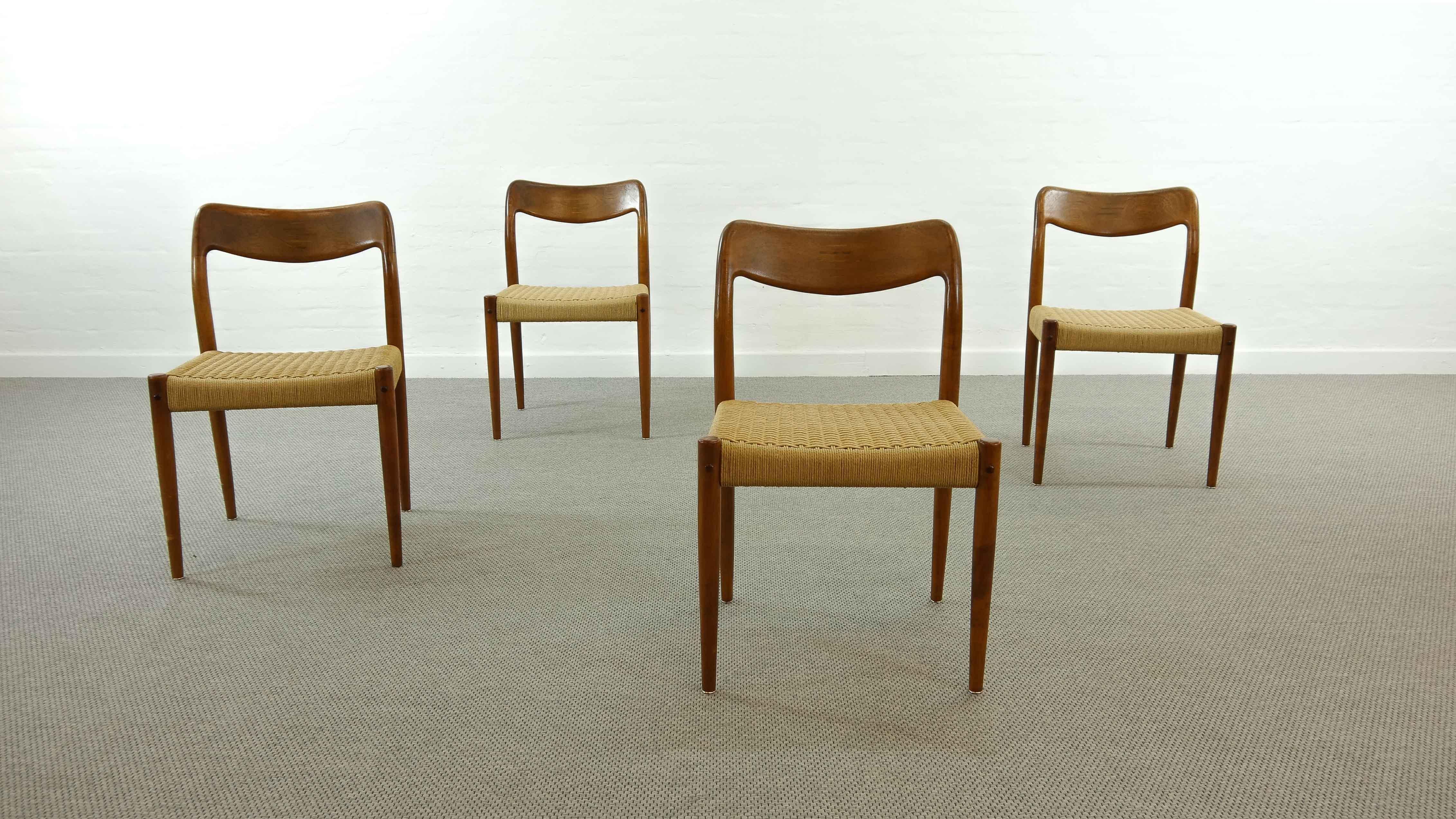 Set of 4 vintage teak chairs, designed by Johannes Andersen 60s for Uldum Møbelfabrik, Denmark. Chairs feature organic shaped backrests with horizontal inlayed joints. Papercord seat areas are in good condition.