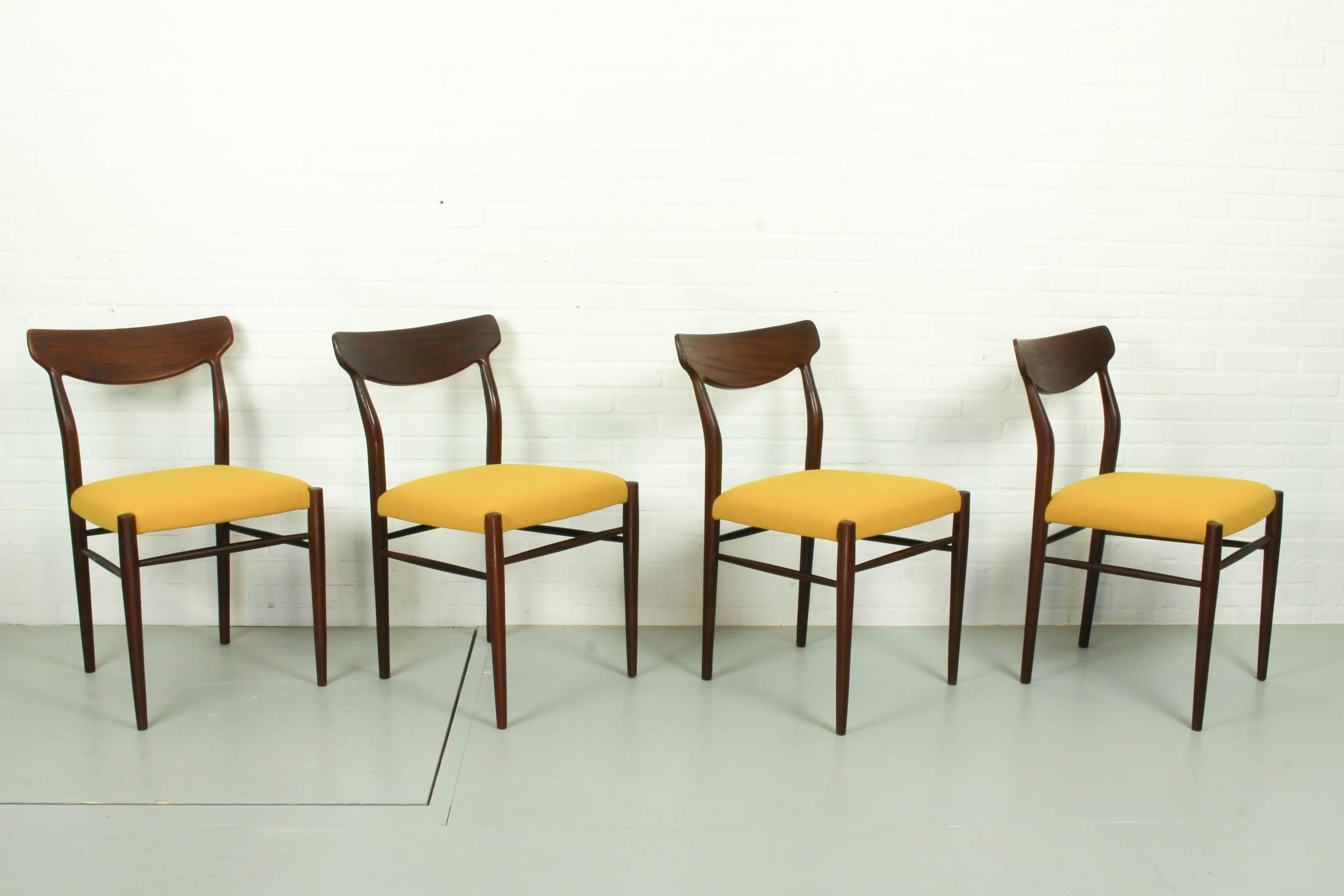 Beautiful dining chairs in teak designed by Harry Ostergaard for Randers Mobelfabrik, Denmark 1950s. The deep dark brown teak frames contrasts nicely with the new Kvadrat Hallingdal yellow upholstery. 

The dimensions are: 78cm H, 49cm W and 54cm