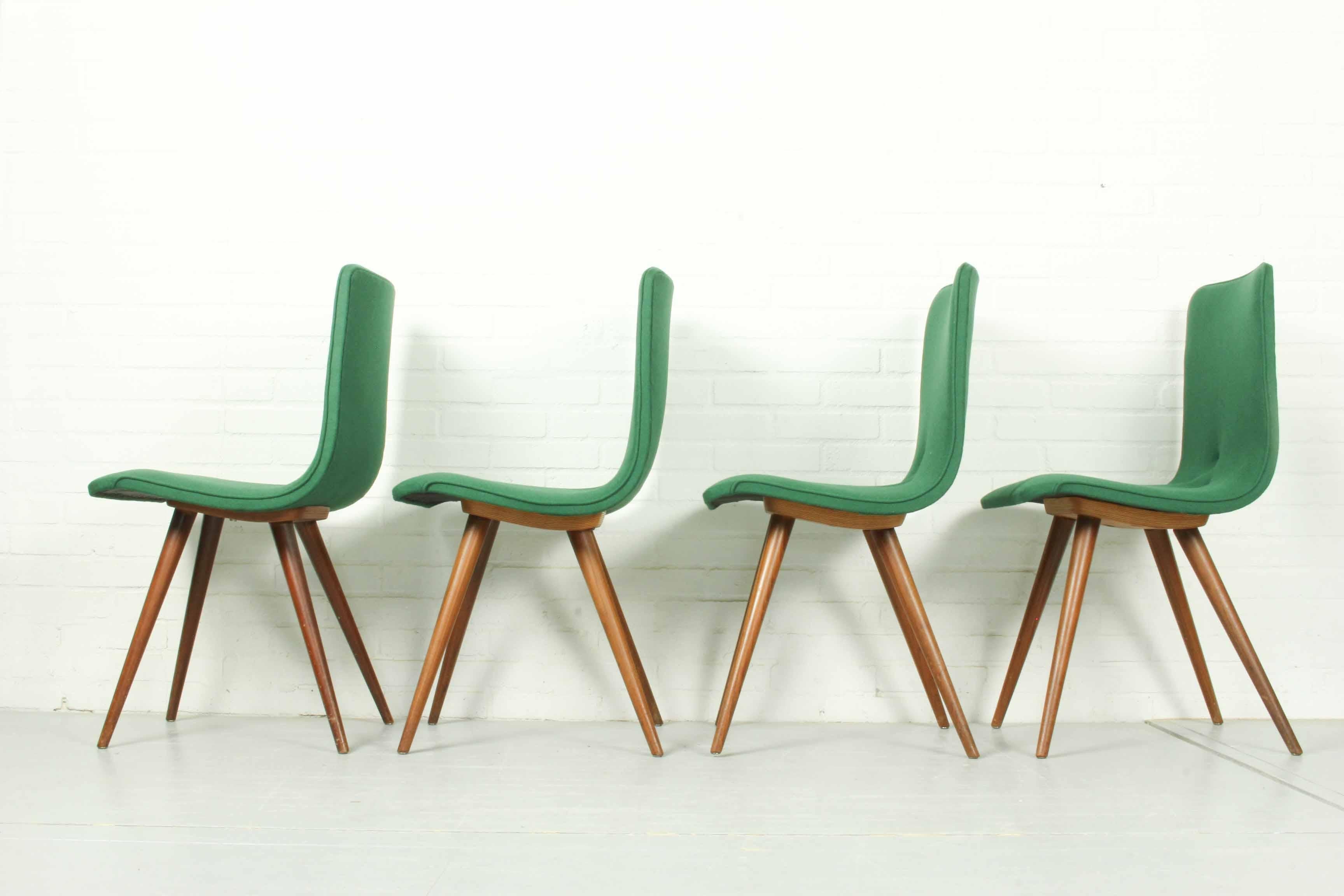Set of four teak dining chairs by GJ Van Os and made at Furniture Factory G.J. Van Os N.V. in Culemborg (Netherlands) in the 1950s. In very good condition with new green woolfelt upholstery.