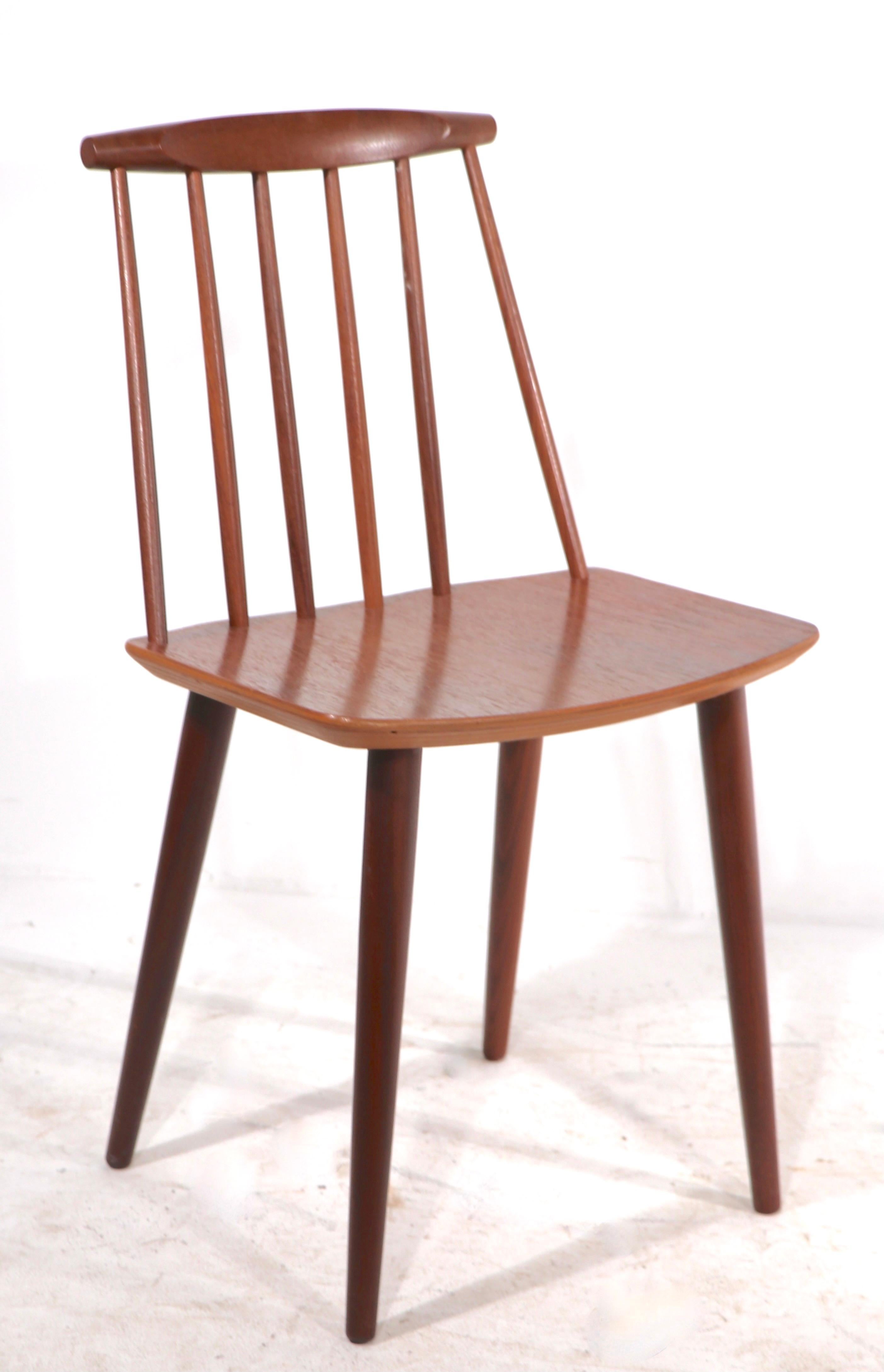 Iconic Danish Modern J 77 dining chairs in teak, designed by Folke Palsson made by FDB Mobler - Denmark circa 1960's. Timeless modern style, still relevant today. Original, clean and ready to use condition. Offered and priced as a set of 4.