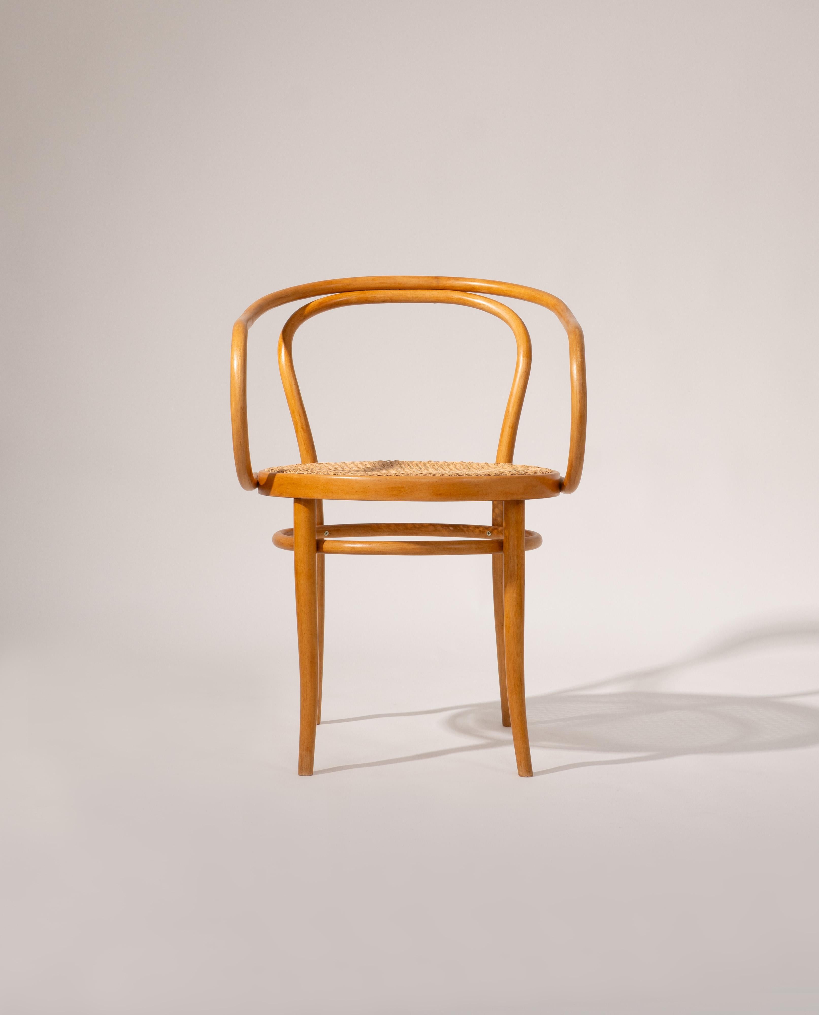 Set of four original Michael Thonet Model 209 chairs manufactured by Ligna around 1960. Each chair features a steam-bent beechwood frame with elegant, continuous curves and a handwoven cane seat. Designed after Michael Thonet’s original concept, the