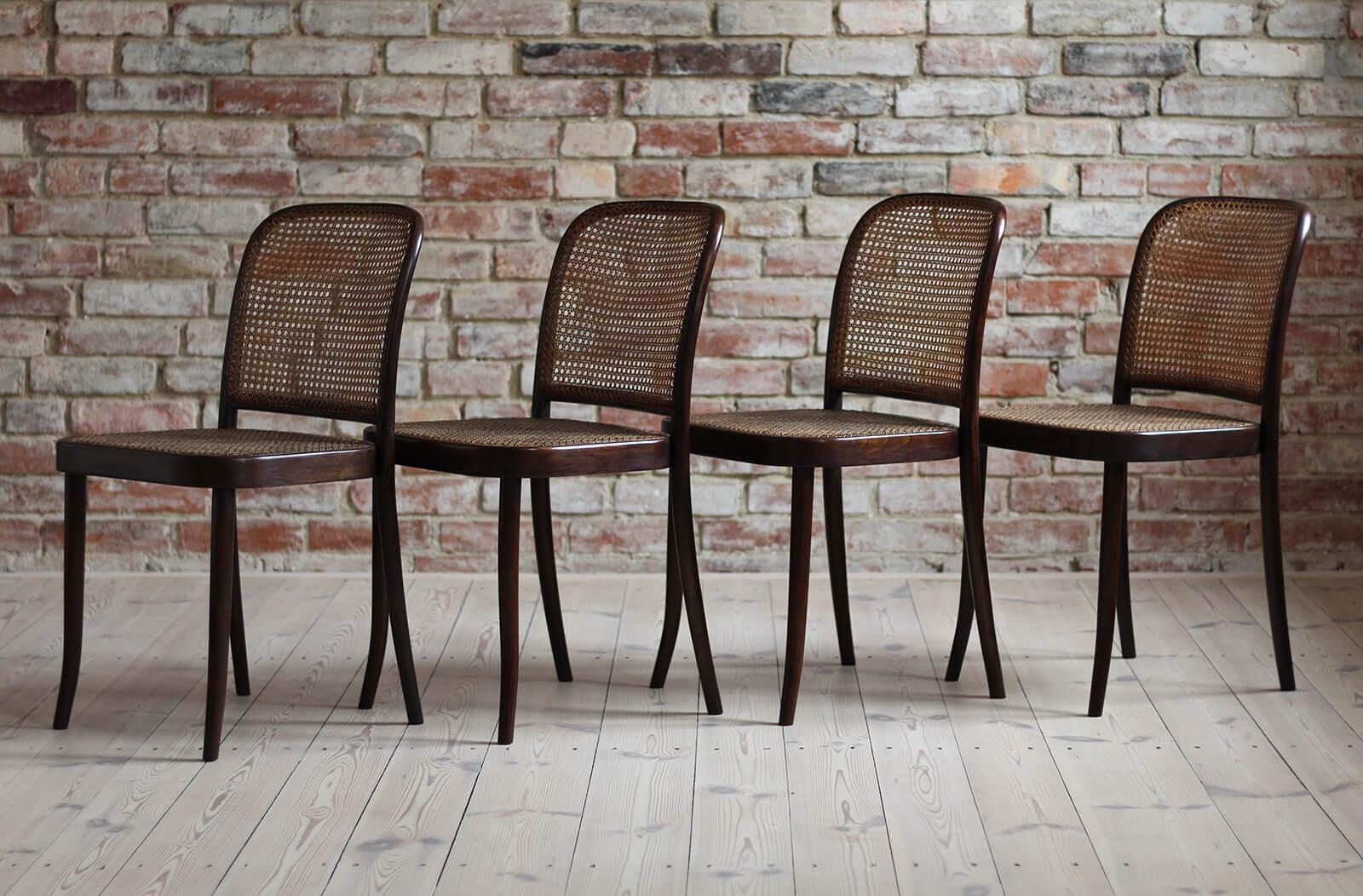This set of four dining chairs was designed by Mr. Josef Hoffmann and produced by famous Thonet brand around 1940s. The chairs have been professionally restored. The wooden surface got a refreshed finish in shellac polish and wax that protects the