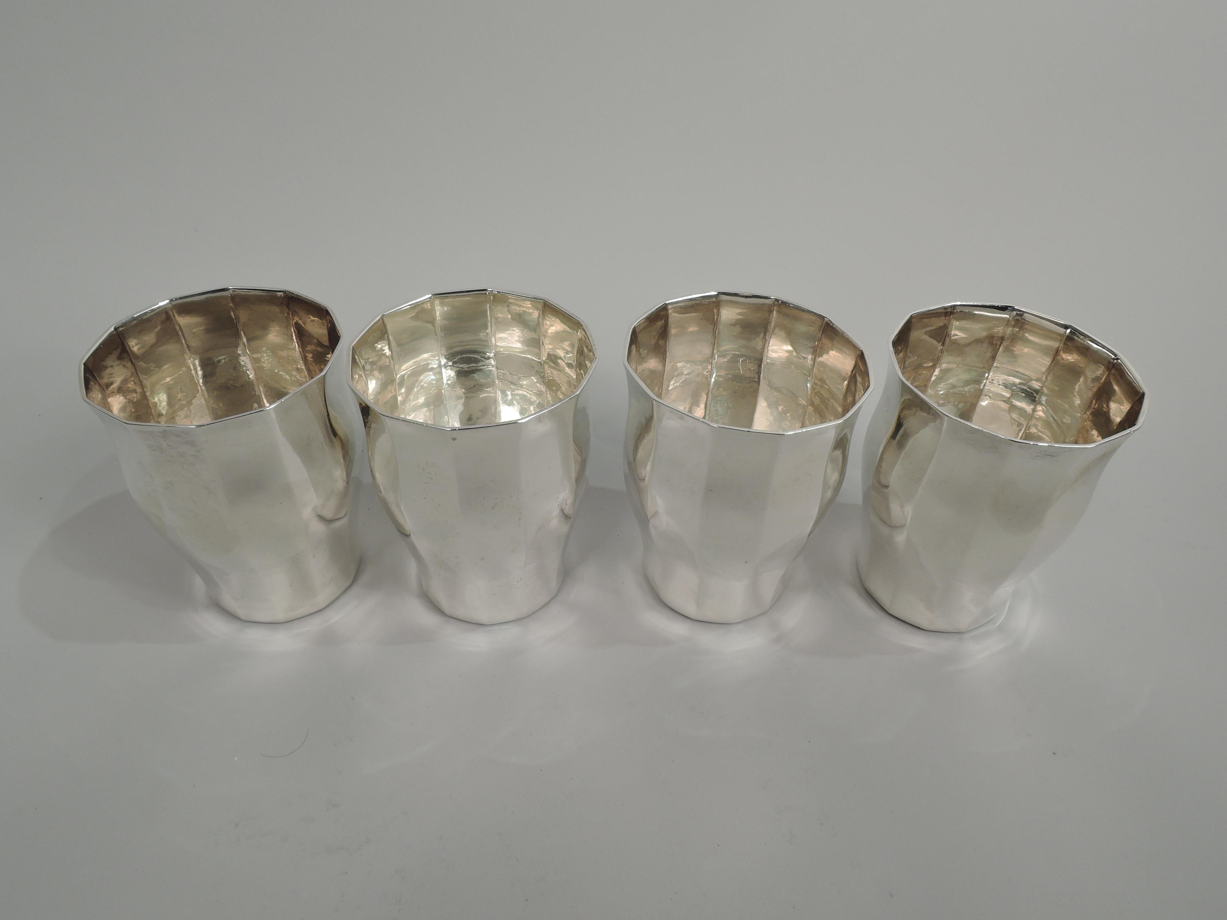 Set of 4 Art Deco Craftsman sterling silver tumblers. Made by Tiffany & Co. in New York, ca 1909. Each: Gentle baluster. Soft and narrow facets. Subtle hand hammering. Fully marked including maker’s stamp, pattern no. 17466 (first produced in 1909),
