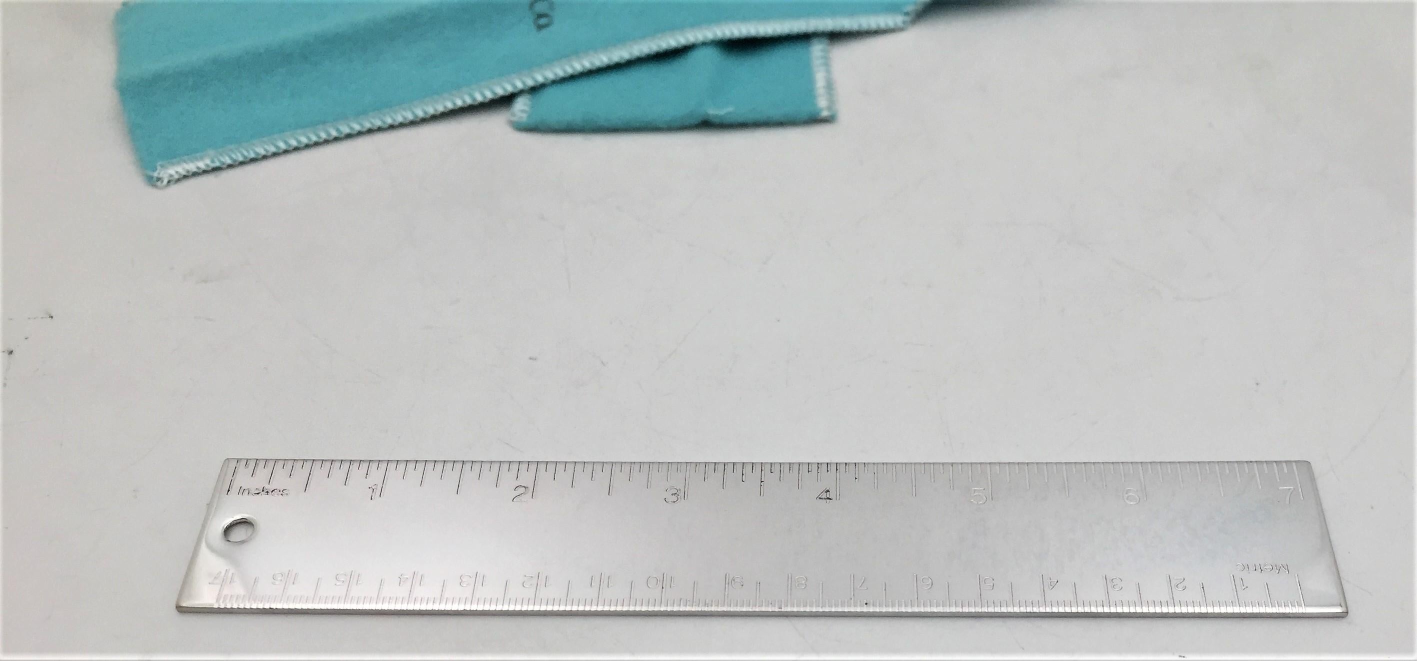 Set of 4 Tiffany & Co. silver plate metric rulers measuring 7 inches (17 centimeters) long. Comes in an authentic Tiffany & Co. branded aqua-colored felt pouch. Brand new condition. Great unisex gift for any holiday or occasion, birthday, or