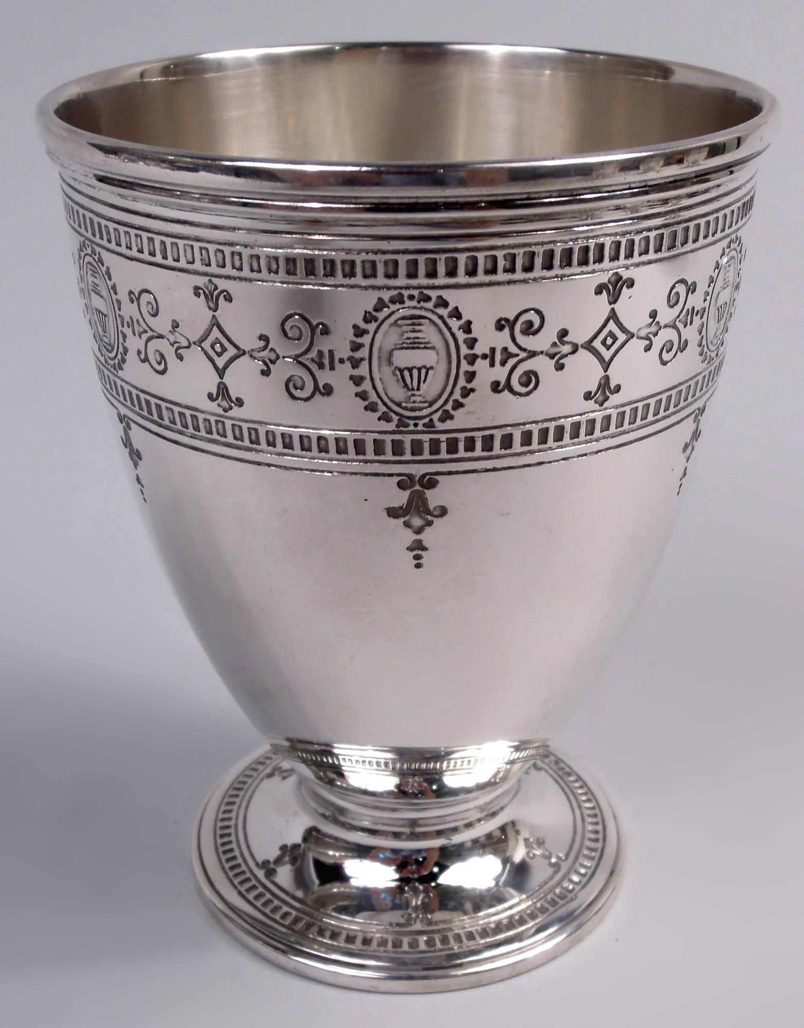 Set of 4 Hamilton Engraved sterling silver goblets. Made by Tiffany & Co. in New York, ca 1927. Ovoid bowl on raised foot. Acid-etched and engraved ornament. On bowl, amphora-inset ovals and chased pendant flowers and scrolls between dentil borders;