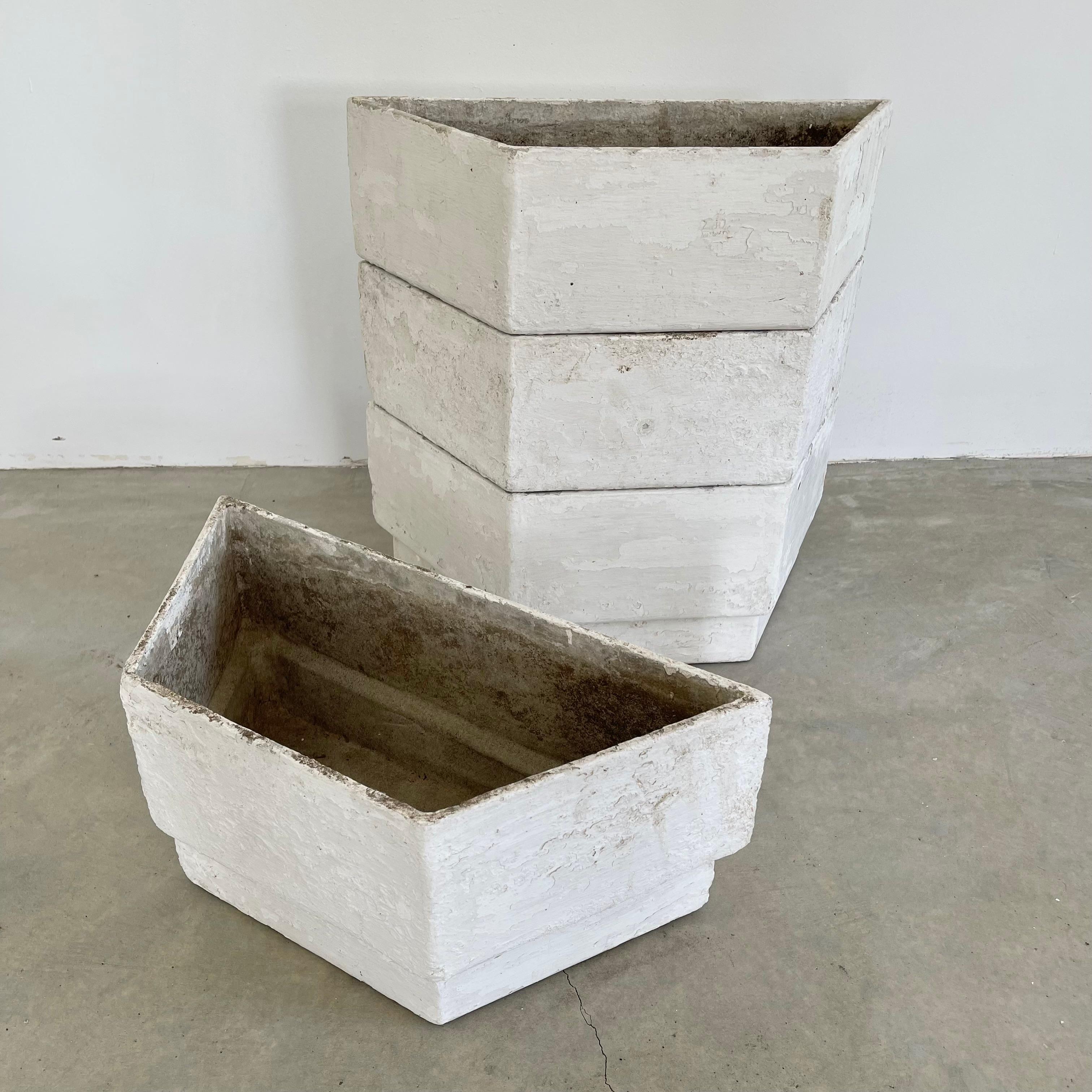 Unique set of trapezoid stacking concrete planters by Swiss Architect Willy Guhl. All trapezoids share the same dimensions. Pieces can be arranged in a multitude of ways. Gorgeous detail. Excellent patina and age to concrete. Cool sculpture for