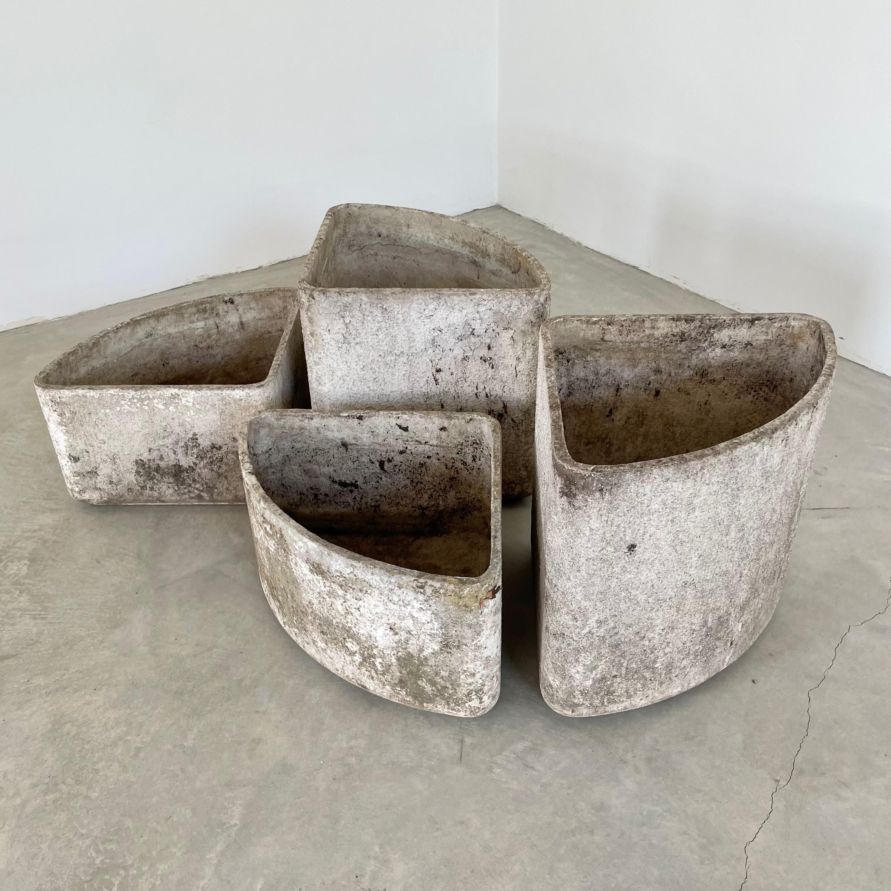 Beautiful set of triangular concrete planters by Swiss Architect Willy Guhl. 4 triangles in two different heights, with the same depth and width. Pieces can be arranged in a multitude of ways. Each triangle sits atop a small indented platform. All