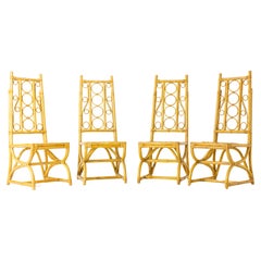 Set of 4 tropically ornate bamboo chairs.