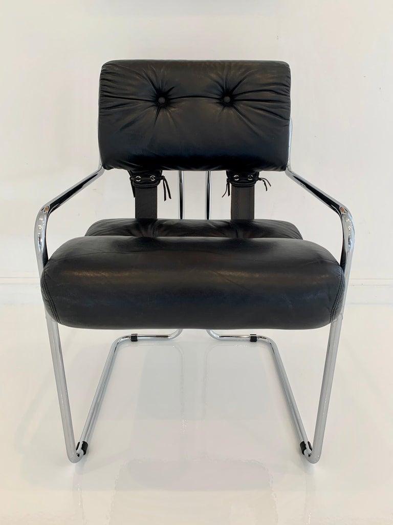 Classic leather chairs by Guido Faleschini for Pace/Mariani. Tubular chrome chair with black leather upholstery and black leather straps connecting seat back with seat bottom. Good condition with wear as shown. Great color and patina. Extremely