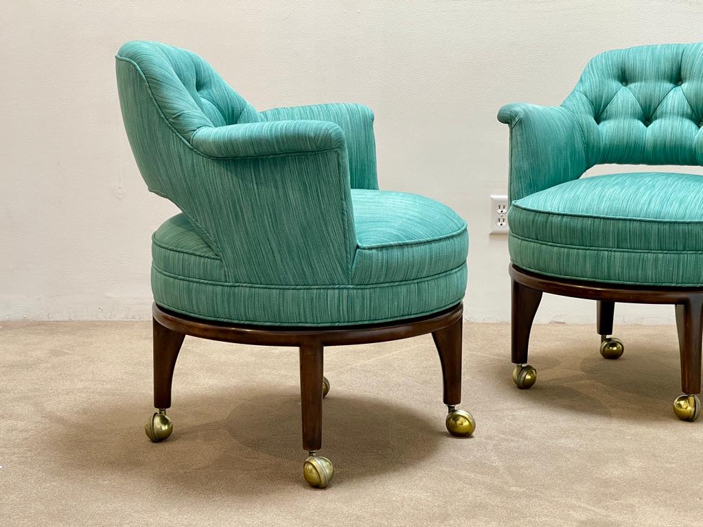 Upholstered set of 4 chairs by Monteverdi Young. Perfect for your game table. Featuring casters that slide the entire chair. Upholstered top swivels separately from wooden base. Fabric is original, vibrant, durable and beautiful. Seat very
