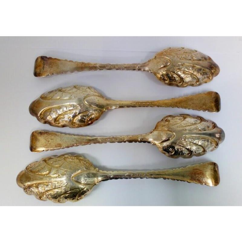 In good condition, this is a lovely set of four serving. The gilt is a little worn in some places but this is commensurate with their age. They are beautifully decorated with a repoussé design. They have empty oval cartouches on the handles. The