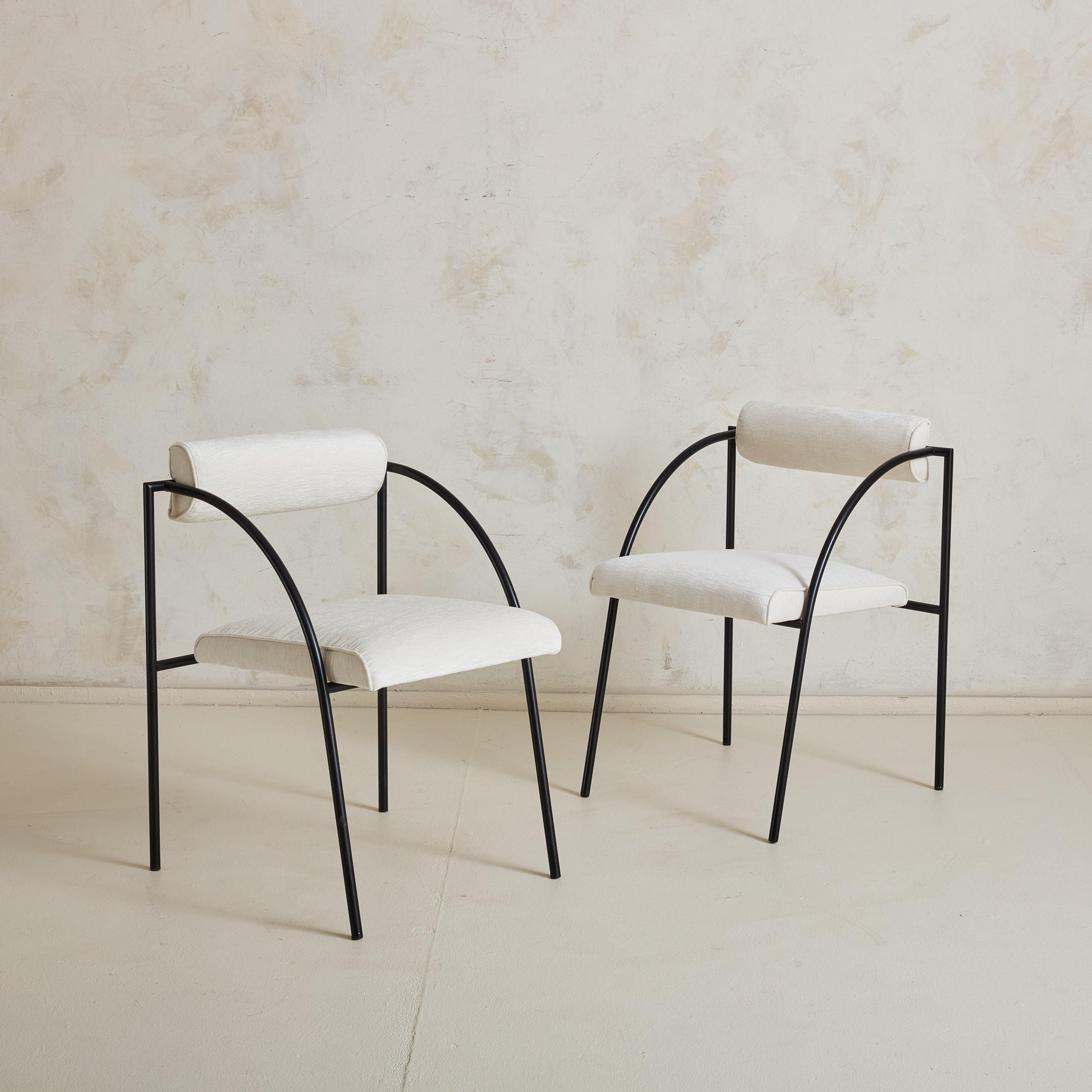 A pair of Postmodern ‘Vienna’ armchairs designed by Rodney Kinsman for Italian manufacturer Bieffeplast, Padova in the 1980s. These sculptural chairs feature tubular black metal frames with dramatic curved-profile arms. The petite, half-round