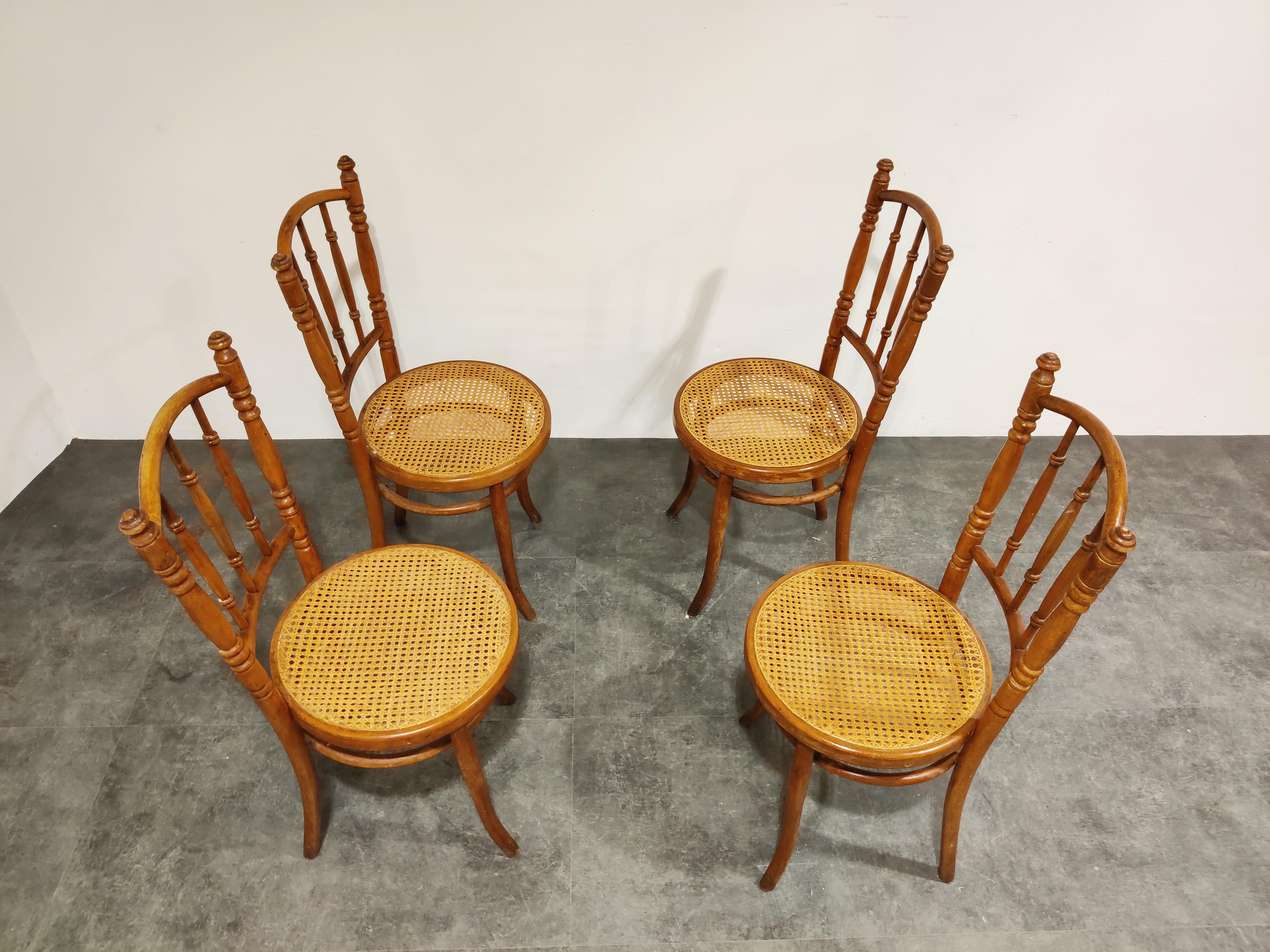Set of 4 bentwooden dining chairs with rattan seats.

The chairs can be either from Thonet or J&J Kohn. They are not stamped. 

Good condition, no damages to the rattan. One finial has a light damage (as seen on the image). 

Due to their