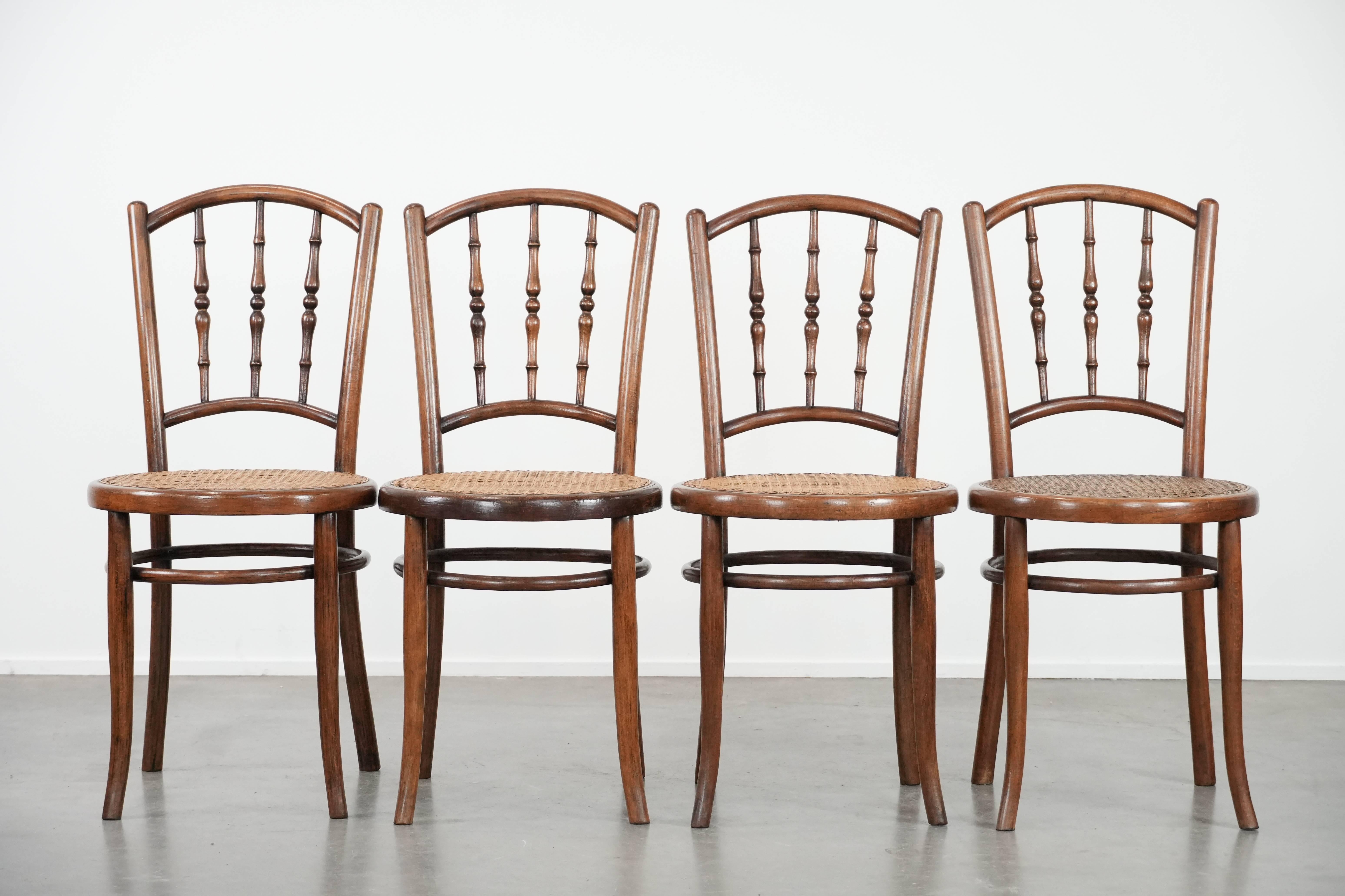 This nice set of 4 chairs is by Jacob & Josef Kohn Wien and features an elegantly curved wooden frame, a wicker seat, and a decorative backrest, giving them a timeless and cosy look. They can be easily placed at both an antique and a modern dining